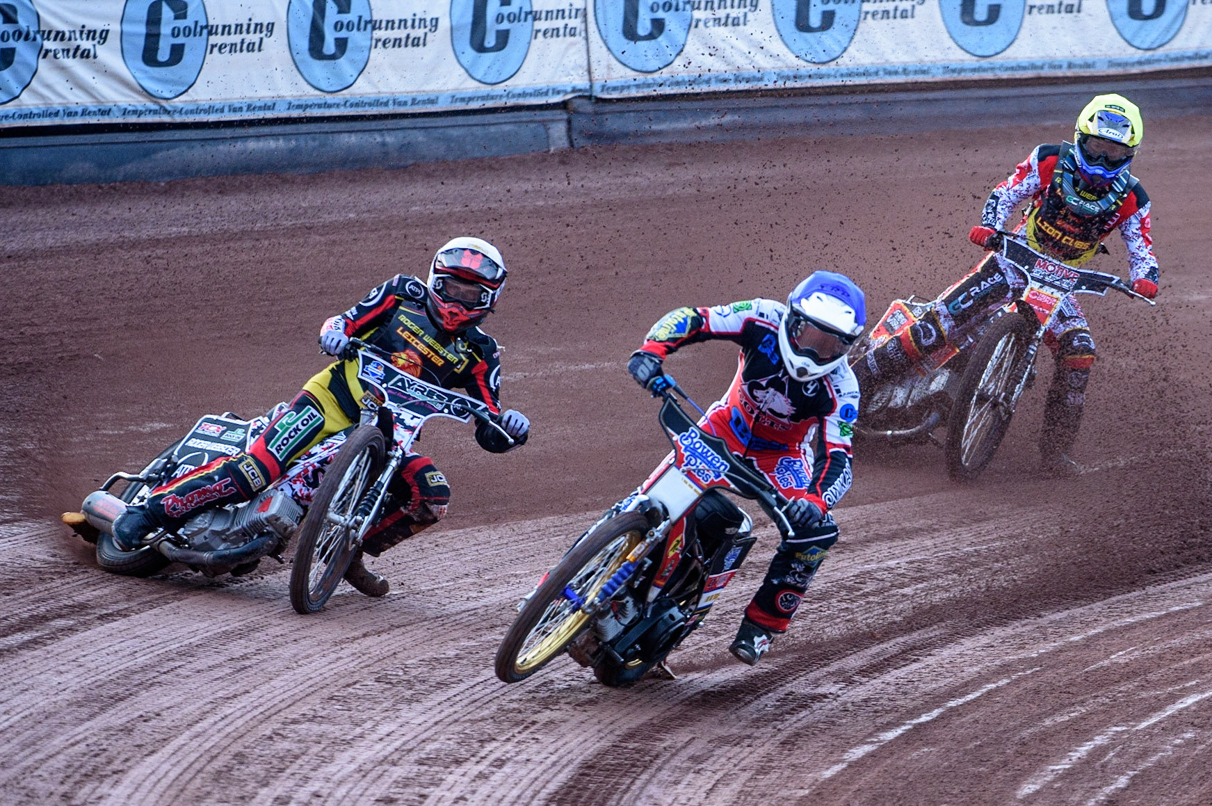 MANCHESTER, UK. JULY 29TH  Paul Bowen  (Blue) picks up some drive causing him to fall as he leads Joe Lawlor  (White) and Tom Spencer   (Yellow)  during the National Development League match between Belle Vue Colts and Leicester Lion Cubs at the National Speedway Stadium, Manchester on Thursday 29th July 2021. (Credit: Ian Charles | MI News)