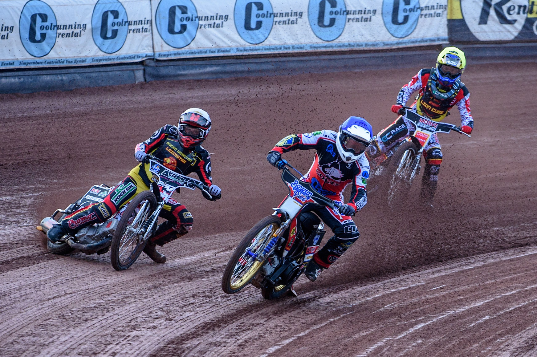 MANCHESTER, UK. JULY 29TH  Paul Bowen  (Blue) picks up some drive causing him to fall as he leads Joe Lawlor  (White) and Tom Spencer   (Yellow)  during the National Development League match between Belle Vue Colts and Leicester Lion Cubs at the National Speedway Stadium, Manchester on Thursday 29th July 2021. (Credit: Ian Charles | MI News)