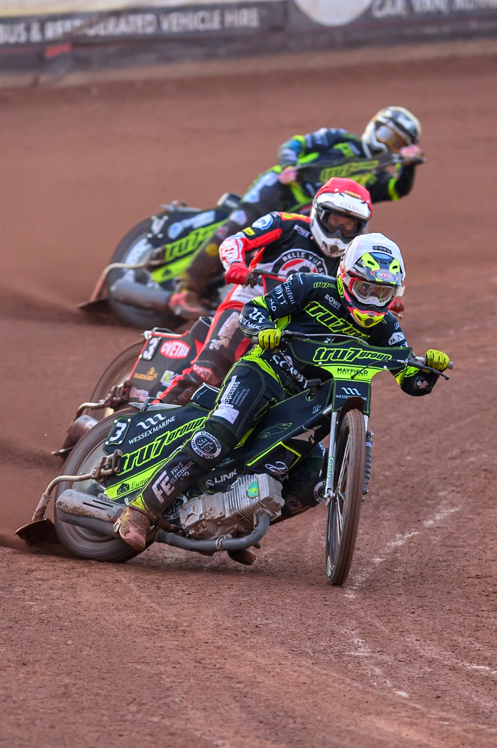 Richard Lawson of Ipswich Witches  in White leading Peter Kildemand of Belle Vue Aces  in Red and Scott Nicholls of Ipswich Witches  in Yellow during the Rowe Motor Oil Premiership match between Belle Vue Aces and Ipswich Witches at the National Speedway Stadium, Manchester on Monday 20th April 2026. (Photo: Ian Charles | MI News)