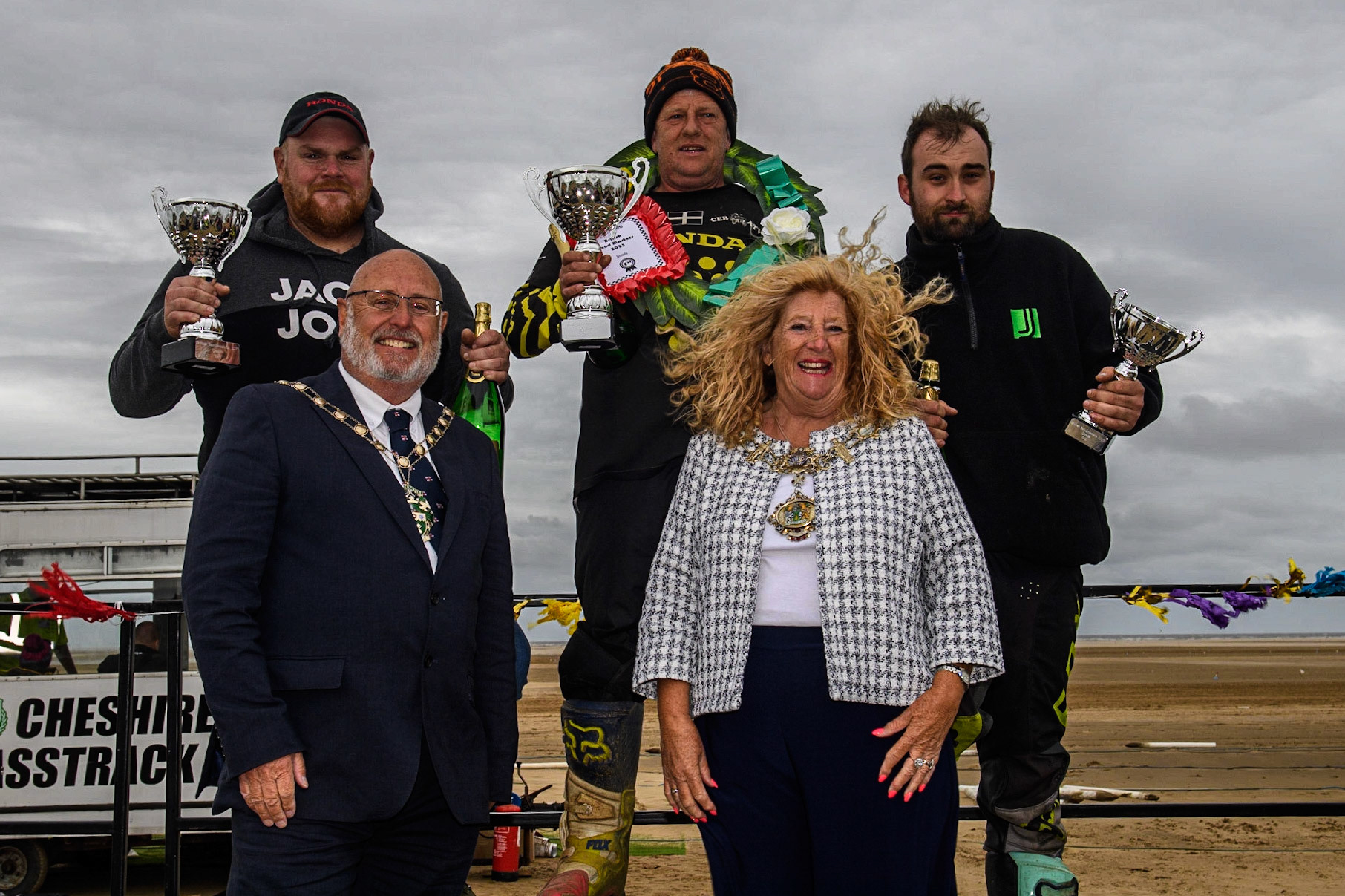Quads Top 3 (l - r) Davey Nixon (99) (2nd) Dan Bray (240) (winner), Liam Whetton (49) (3rd) with (Foreground) Cllr Cheryl Little, The Worshipful Mayer of Fylde (right) with her Consort during the Fylde ACU British Sand Racing Masters Championship at  St Annes on Sea, Lancashire on Sunday 30th July 2023. (Photo: Ian Charles | MI News)