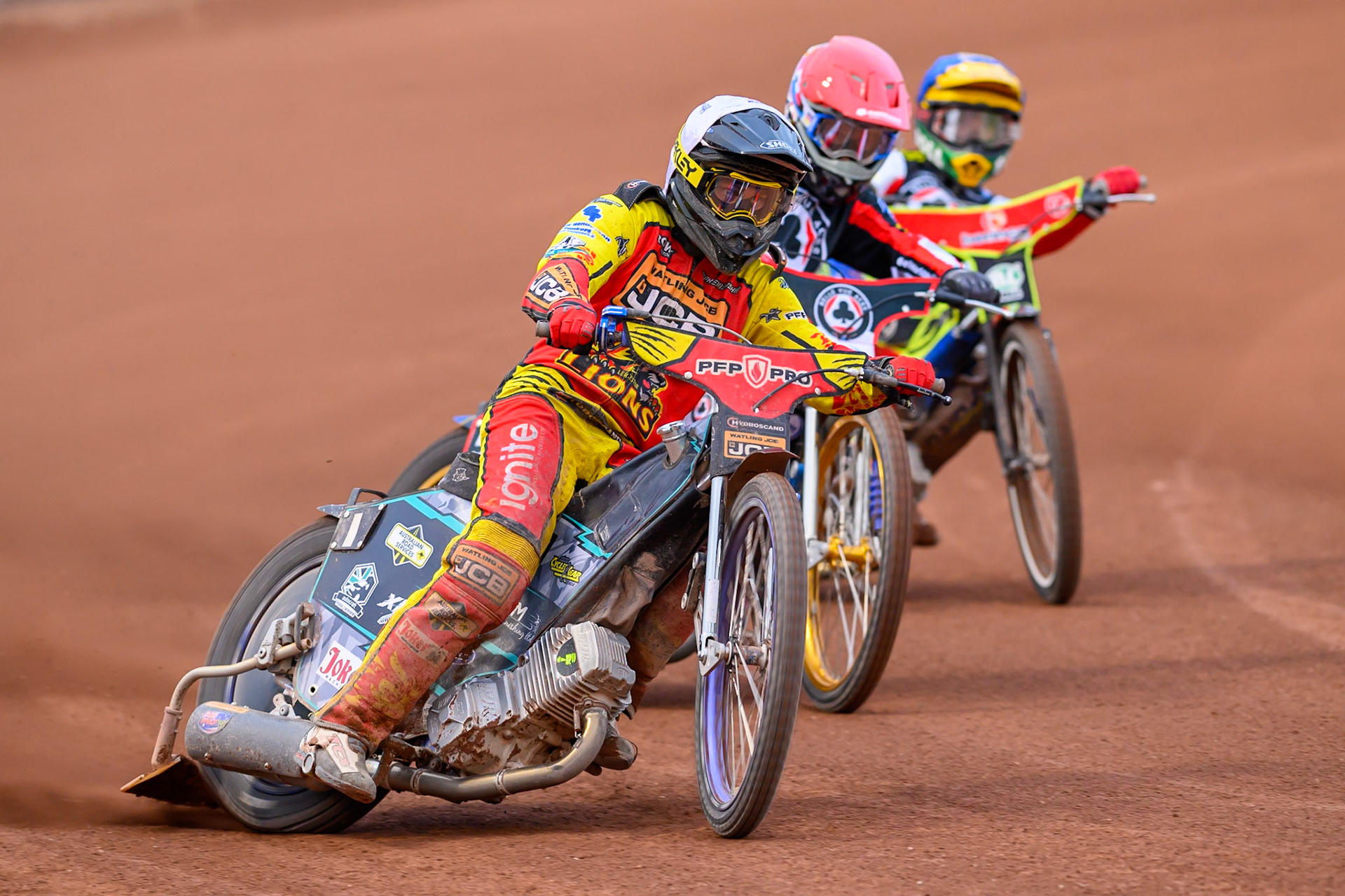 Ryan Douglas of Leicester Lions in White leading Jason Doyle of Belle Vue Aces in Red  and Mitch McDiarmid, Guest Rider for Belle Vue Aces in Blue  during the Rowe Motor Oil Premiership match between Belle Vue Aces and Leicester Lions at the National Speedway Stadium, Manchester on Monday 3rd August 2026. (Photo: Ian Charles | MI News)