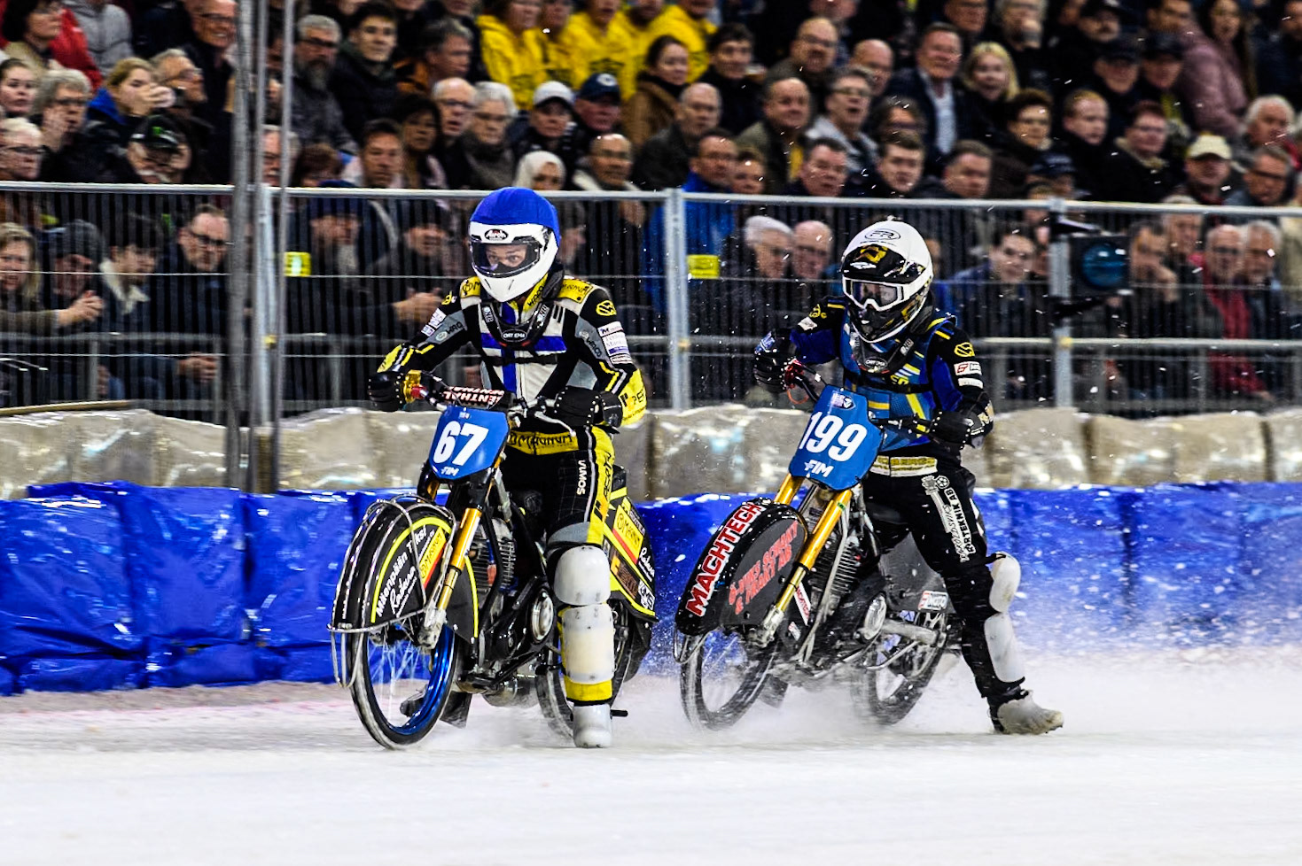 Finland's Heikki Huusko (67) in Blue leading Sweden's Martin Haarahiltunen (199)  in White during the FIM Ice Speedway Gladiators World Championship Final 4 at Ice Rink Thialf, Heerenveen on Sunday 7th April 2024. (Photo: Ian Charles | MI News)