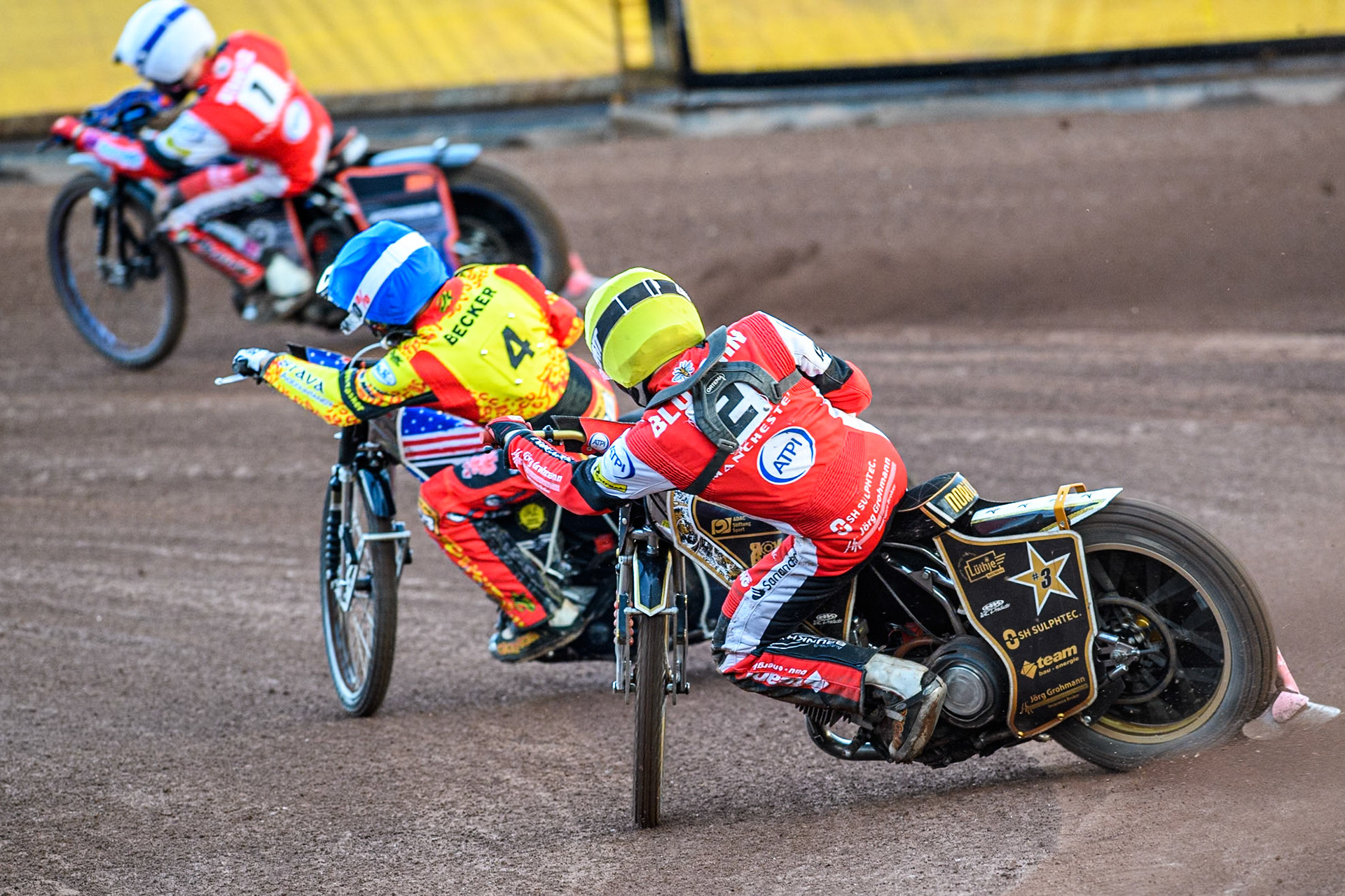 Belle Vue Aces' Norick Blodorn in Yellow chases Leicester Lions' Luke Becker in Blue and Belle Vue Aces' Brady Kurtz in White during the Rowe Motor Oil Premiership match between Leicester Lions and Belle Vue Aces at the Pidcock Motorcycles Arena, Leicester on Thursday 25th July 2024. (Photo: Ian Charles | MI News)