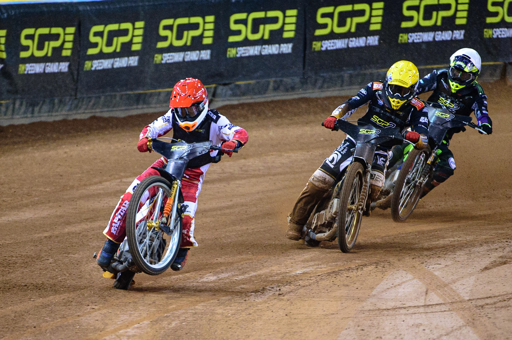 Mateusz Cierniak (Poland)  (Red) picks up some drive coming out of the 2nd turn ahead of Norick Blodorn (Germany)  (Yellow) and Tom Brennan (Great Britain)  (White) during the FIM  Speedway Grand Prix  2 of Great Britain at the Principality Stadium, Cardiff on Sunday 14th August 2022. (Credit: Ian Charles | MI News)