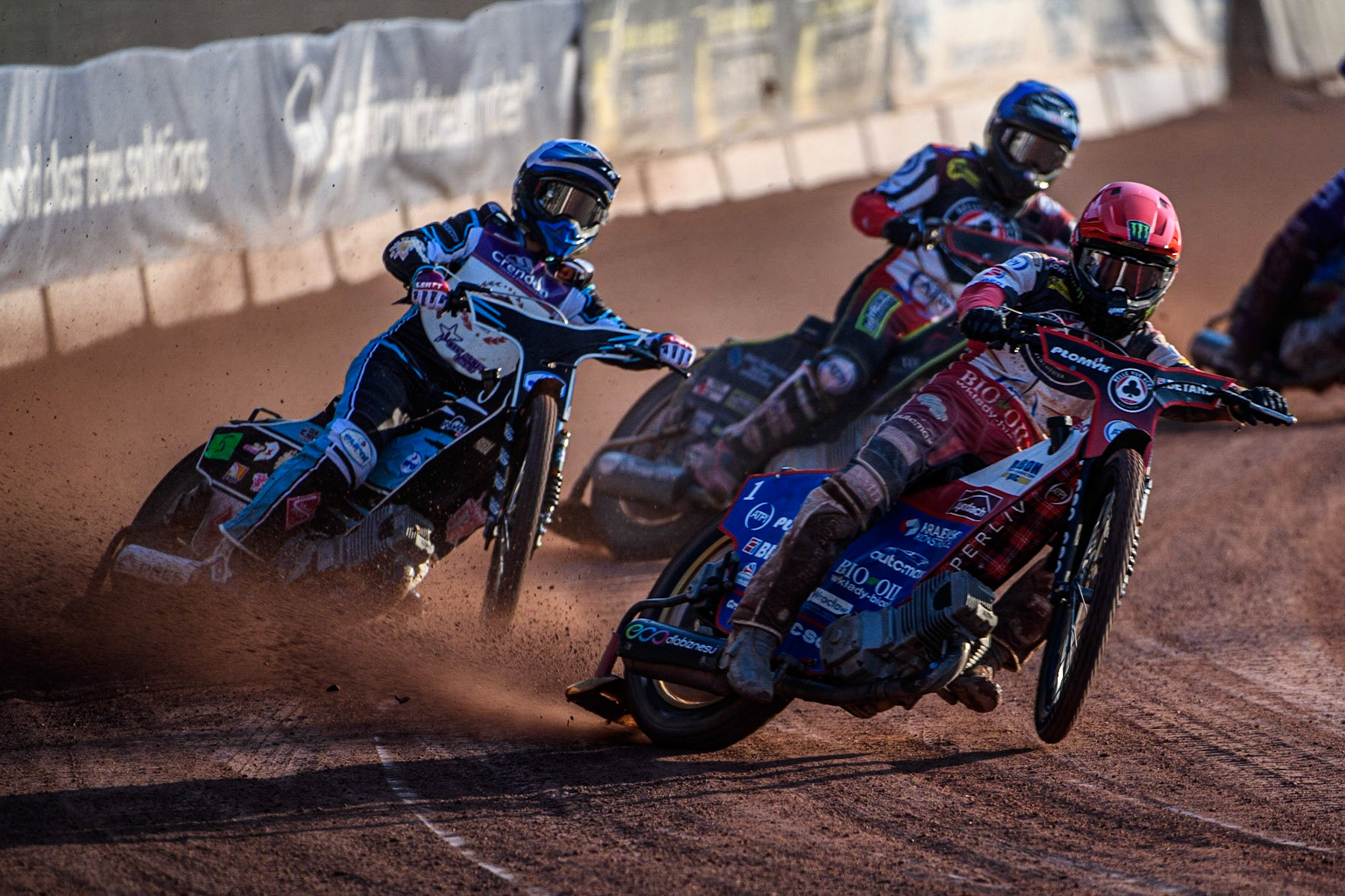 Dan Bewley (Red) leads Vadim Tarasenko (White) and Tom Brennan (Blue) during the Sports Insure Premiership match between Belle Vue Aces and Peterborough at the National Speedway Stadium, Manchester on Monday 19th June 2023. (Photo: Ian Charles | MI News)