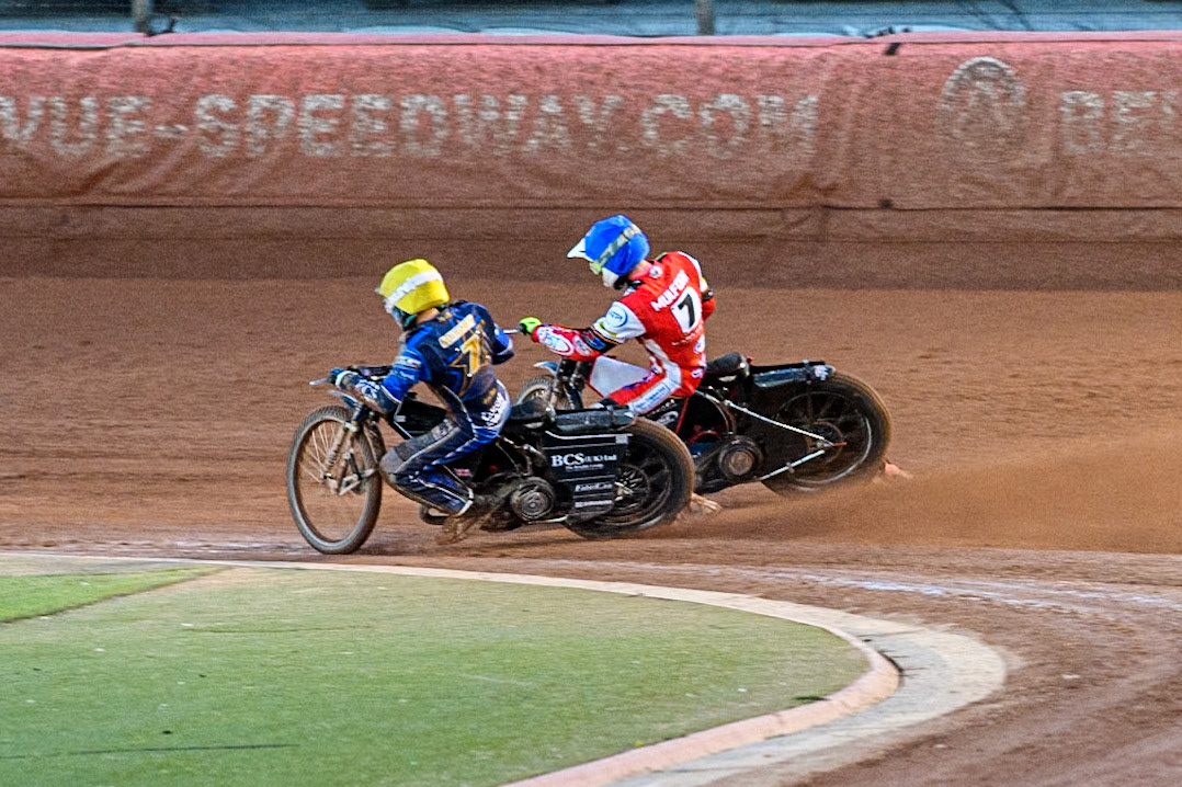 Jake Mulford of Belle Vue Aces in Blue rides outside Ashton Boughen of Kings Lynn Stars in Yellow during the Rowe Motor Oil Premiership match between Belle Vue Aces and King's Lynn Stars at the National Speedway Stadium, Manchester on Monday 5th April 2025. (Photo: Ian Charles | MI News)