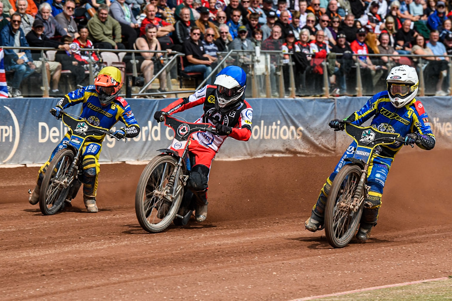 Sheffield Tigers' Josh Pickering  in White rides inside Belle Vue Aces' Antti Vuolas  in Blue and Sheffield Tigers' Jason Edwards  in Yellow during the Rowe Motor Oil Premiership match between Belle Vue Aces and Sheffield Tigers at the National Speedway Stadium, Manchester on Monday 26th August 2024. (Photo: Ian Charles | MI News)