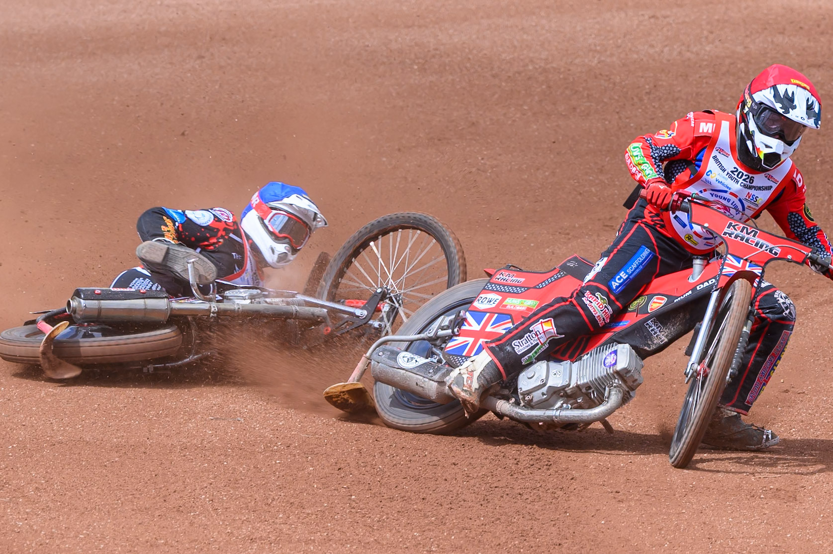 BRITISH YOUTH CHAMPIONSHIP (500cc): Kayden Mundy (8) in Red rides inside Dylan Huthwaite (9)  in Blue who then falls during the British Youth Speedway Championship at the National Speedway Stadium, Manchester on Sunday 10th May 2026. (Photo: Ian Charles | MI News)