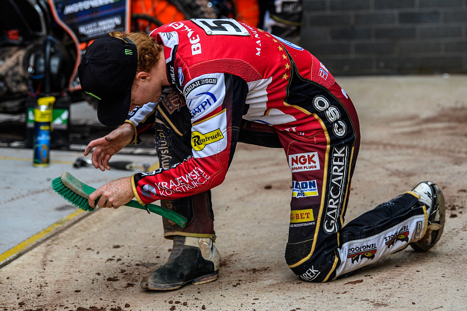 Dan Bewley brushes the shale off his kevlars and boots during the Sports Insure Premiership match between Belle Vue Aces and Leicester Lions at the National Speedway Stadium, Manchester on Monday 28th August 2023. (Photo: Ian Charles | MI News)