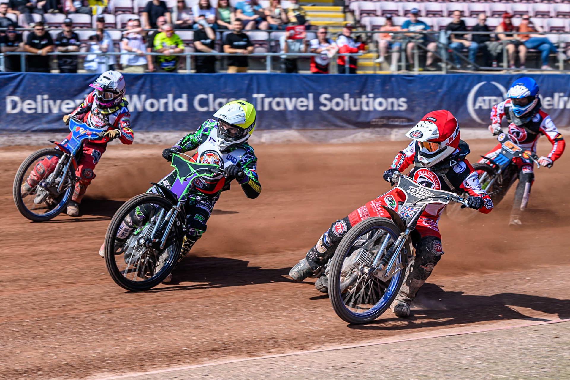 Jack Shimelt of Belle Vue Colts   in Red rides inside Kai Ward of Middlesborough Tigers  in Yellow, Stene Pijper of Middlesborough Tigers  in White with Billy Budd of Belle Vue Colts  in Blue behind during the WSRA National Development League match between Belle Vue Colts and Middlesbrough Tigers at the National Speedway Stadium, Manchester on Sunday 10th August 2025. (Photo: Mark Fletcher | MI News)