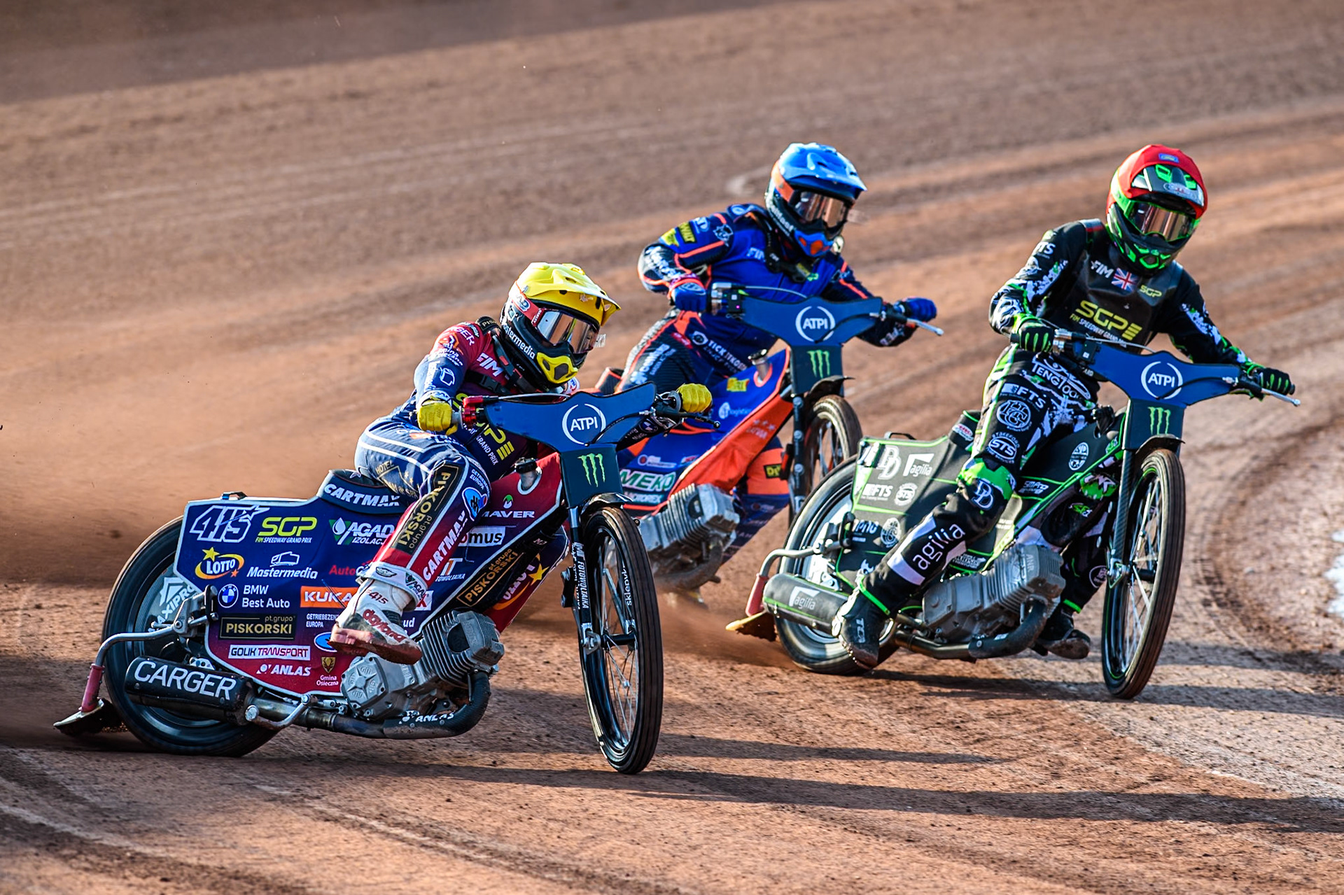 Dominik Kubera (415) of Poland in Yellow rides outside Wild Card Charles Wright (16) of Great Britain in Red and Andzejs Lebedevs (29) of Latvia in Blue during the ATPI FIM Speedway Grand Prix Round 5 at the National Speedway Stadium, Manchester, on Saturday 14th June 2025. (Photo: Ian Charles | MI News)