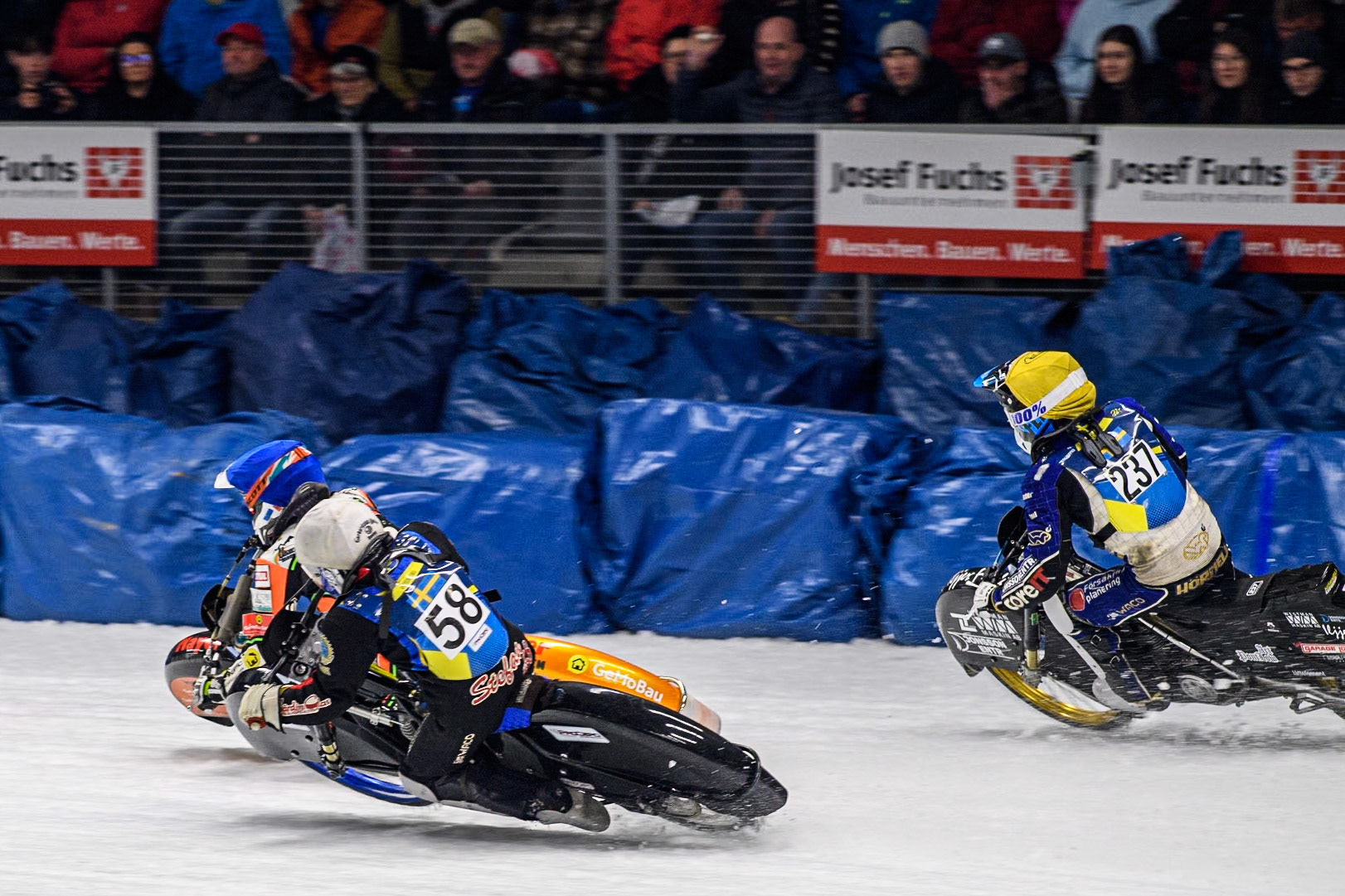 Sweden's Stefan Svensson (58) (White) inside Germany's Markus Jell (82) (Blue) with Sweden's Jimmy Hörnell Lidfalk (237) (Yellow) behind during the FIM Ice Speedway Gladiators World Championship Final 1 at the Max-Aicher-Arena, Inzell on Saturday 23 March 2024. (Photo: Ian Charles | MI News)