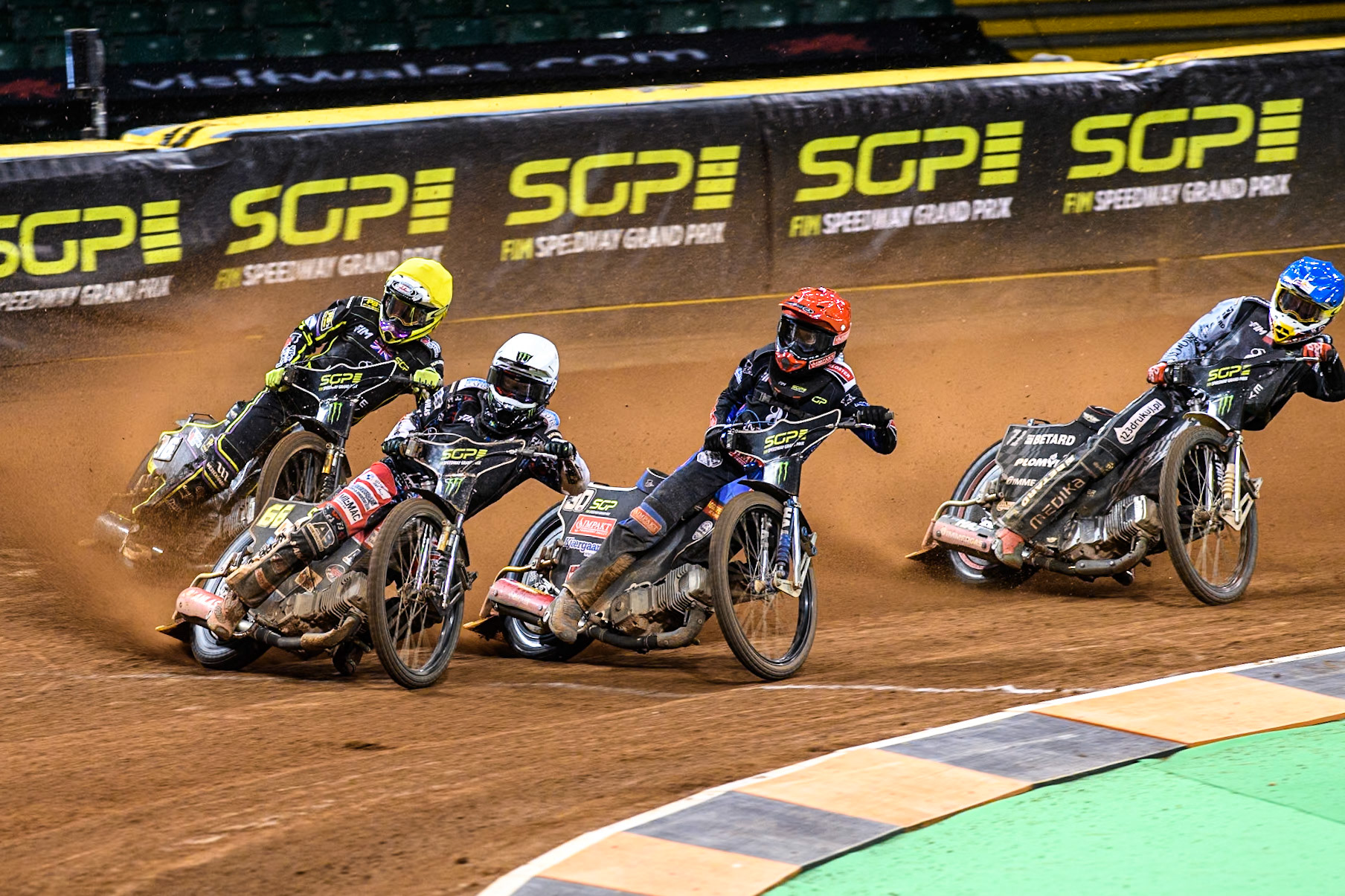Fredrik Lindgren (66) of Sweden in White leading Leon Madsen (30) of Denmark in Red Tom Brennan (16) Wild card rider of Great Britain in Yellow and Maciej Janowski (71) of Poland in Blue during the FIM Speedway Grand Prix of Great Britain at The Principality Stadium, Cardiff on Saturday 17th August 2024. (Photo: Ian Charles | MI News)