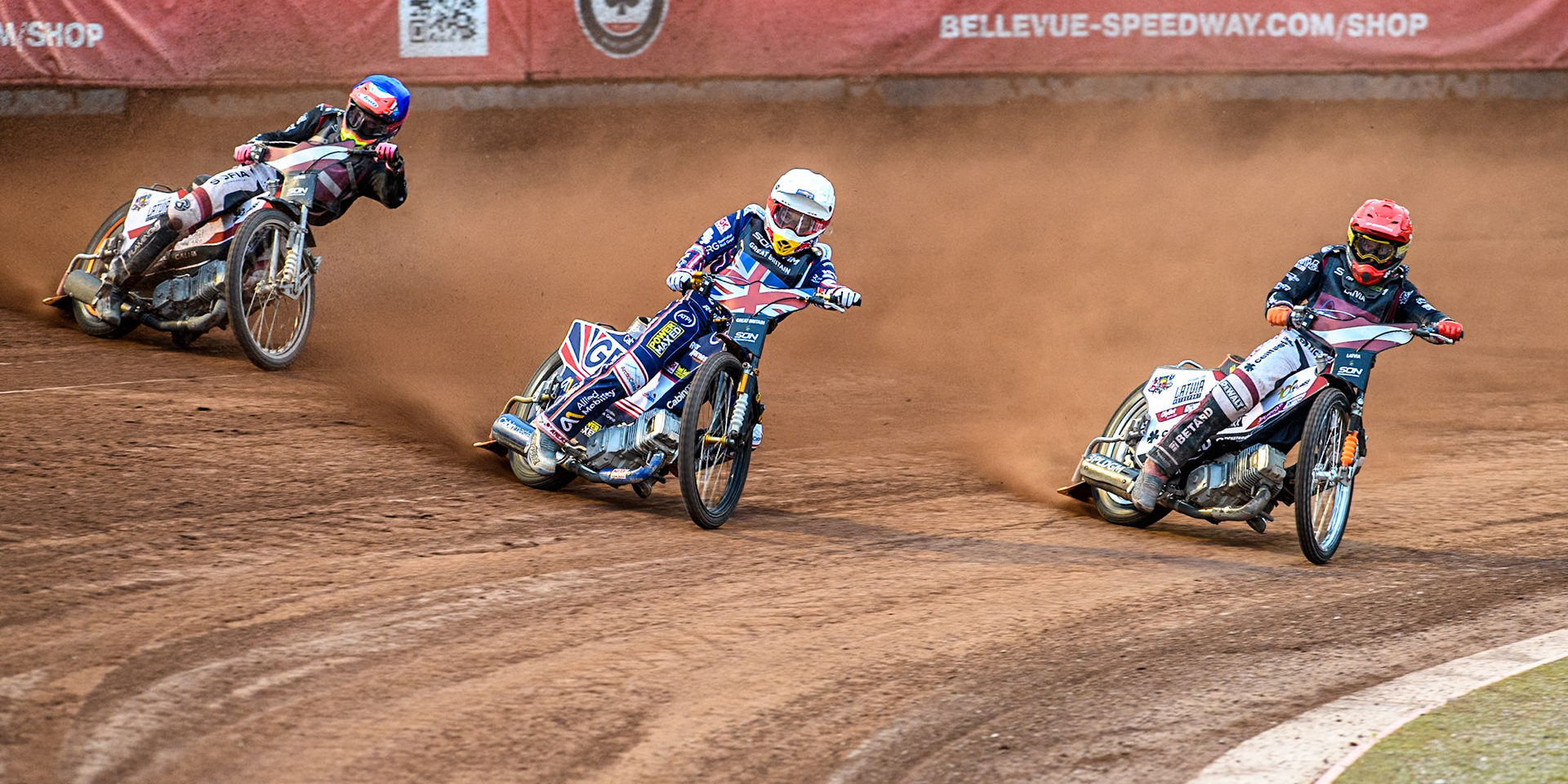 LATVIA v GREAT BRITAIN: Robert Lambert of Great Britain in White leading Andzejs Lebedevs of Latvia in Red and Daniils Kolodinskis of Latvia in Blue during the Monster Energy FIM Speedway of Nation Final at the National Speedway Stadium, Manchester on Saturday 13th July 2024. (Photo: Ian Charles | MI News)