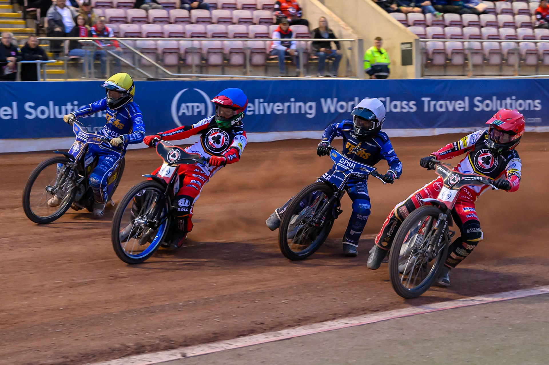 Belle Vue Aces' Dan Bewley in Red rides inside Kings Lynn Stars' Ben Cook in White, Belle Vue Aces' Brady Kurtz in Blue and Kings Lynn Stars' Nicolai Klindt in Yellow during the Rowe Motor Oil Premiership match between Belle Vue Aces and King's Lynn Stars at the National Speedway Stadium, Manchester on Monday 23rd June 2025. (Photo: Ian Charles | MI News)