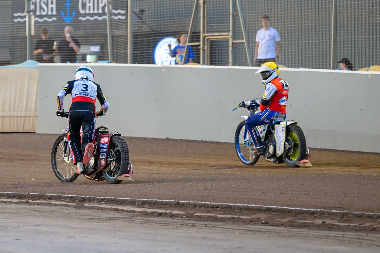 Peter Kildemand of Belle Vue Aces in White  starts to push his bike home to score the final point in Heat 7 as Chris Harris Guest Rider for Belle Vue Aces  looks on during the Rowe Motor Oil Premiership match between Northampton Foxes and Belle Vue Aces at Northampton International Shaleway, Northampton on Thursday 13th August 2026. (Photo: Ian Charles | MI News)