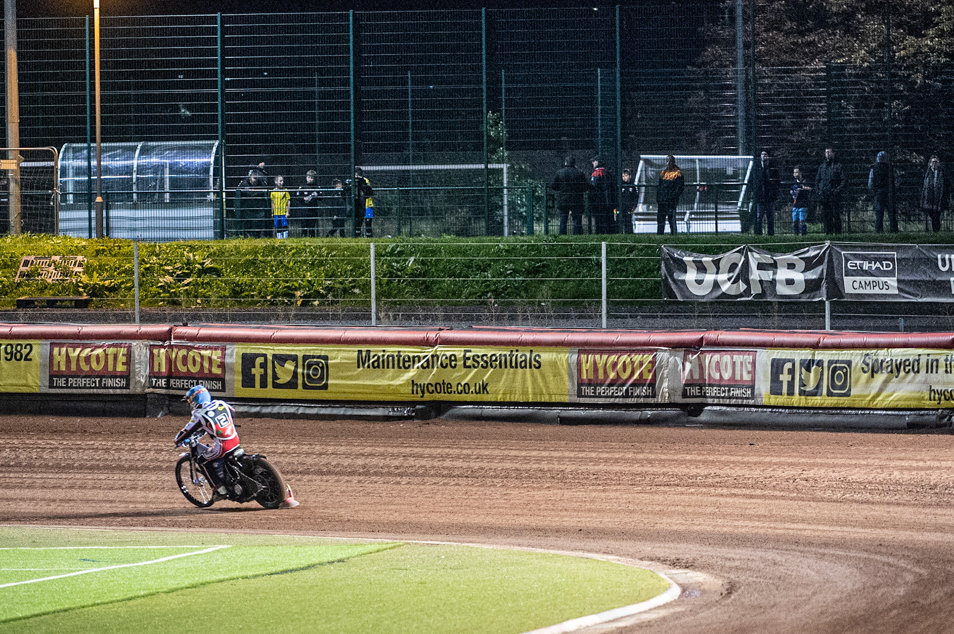 Photo: Ian CharlesPeople using the Football pitches next to the stadium watch the racing Peter Craven Memorial Trophy, National Speedway Stadium, Manchester Thursday  22  October  2020