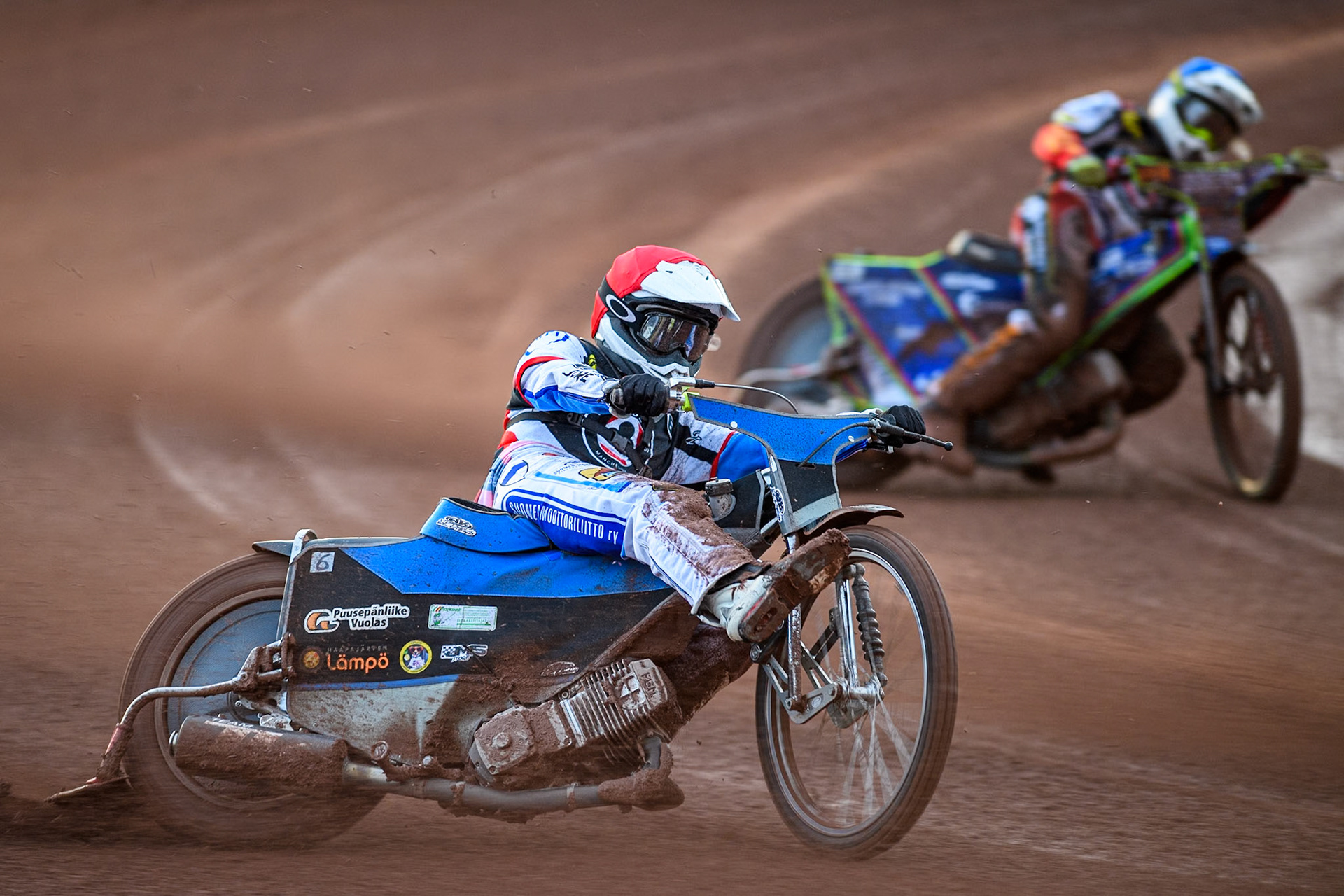 Belle Vue Aces' Antti Vuolas  in Red rides outside Belle Vue Aces' Jake Mulford  in Blue during the Rowe Motor Oil Premiership match between Belle Vue Aces and King's Lynn Stars at the National Speedway Stadium, Manchester on Monday 12th August 2024. (Photo: Ian Charles | MI News)