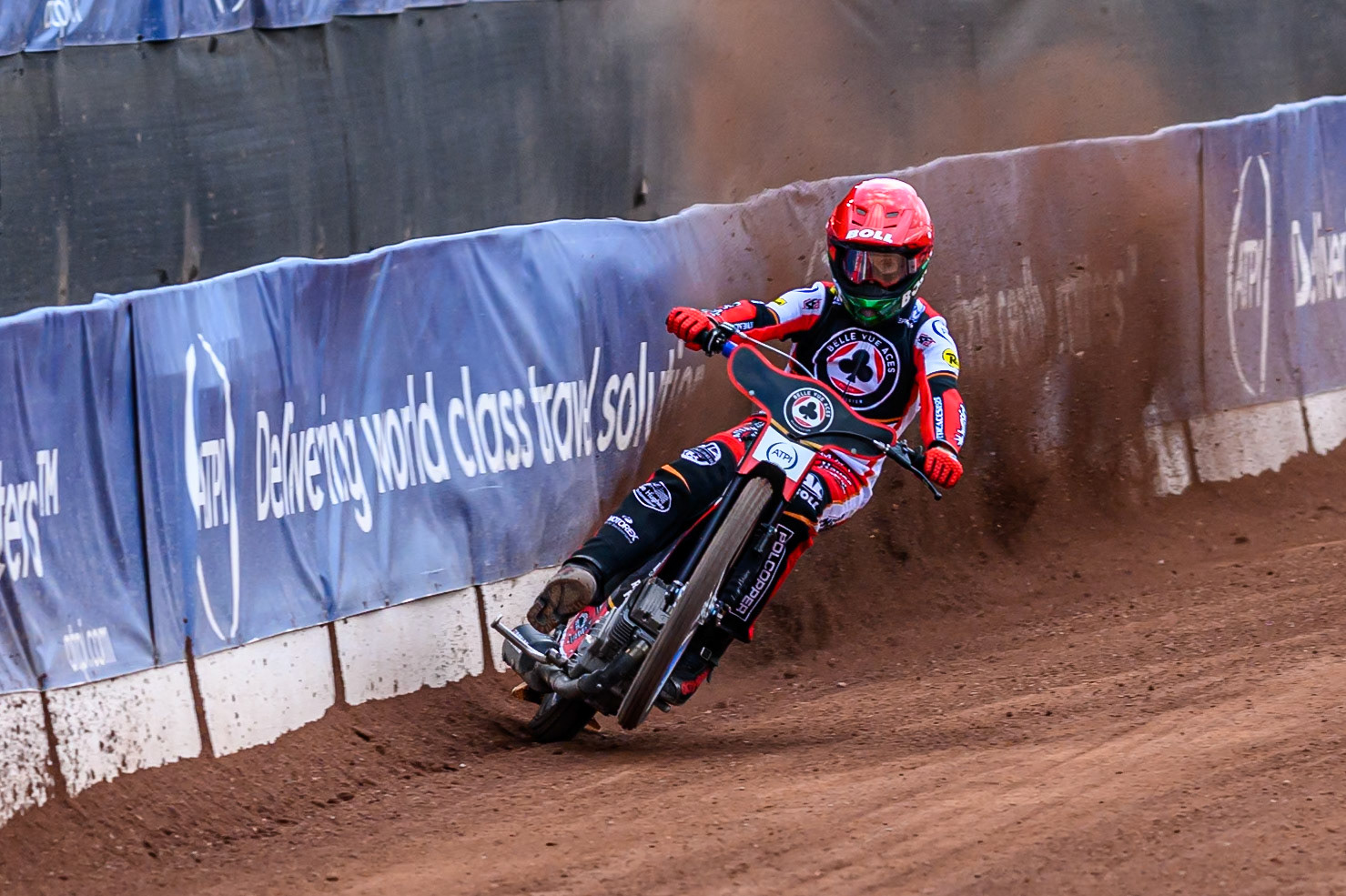 Belle Vue Aces' Brady Kurtz picks up some drive as he uses the dirt build up on the safety fence during the Rowe Motor Oil Premiership match between Belle Vue Aces and King's Lynn Stars at the National Speedway Stadium, Manchester on Monday 23rd June 2025. (Photo: Ian Charles | MI News)