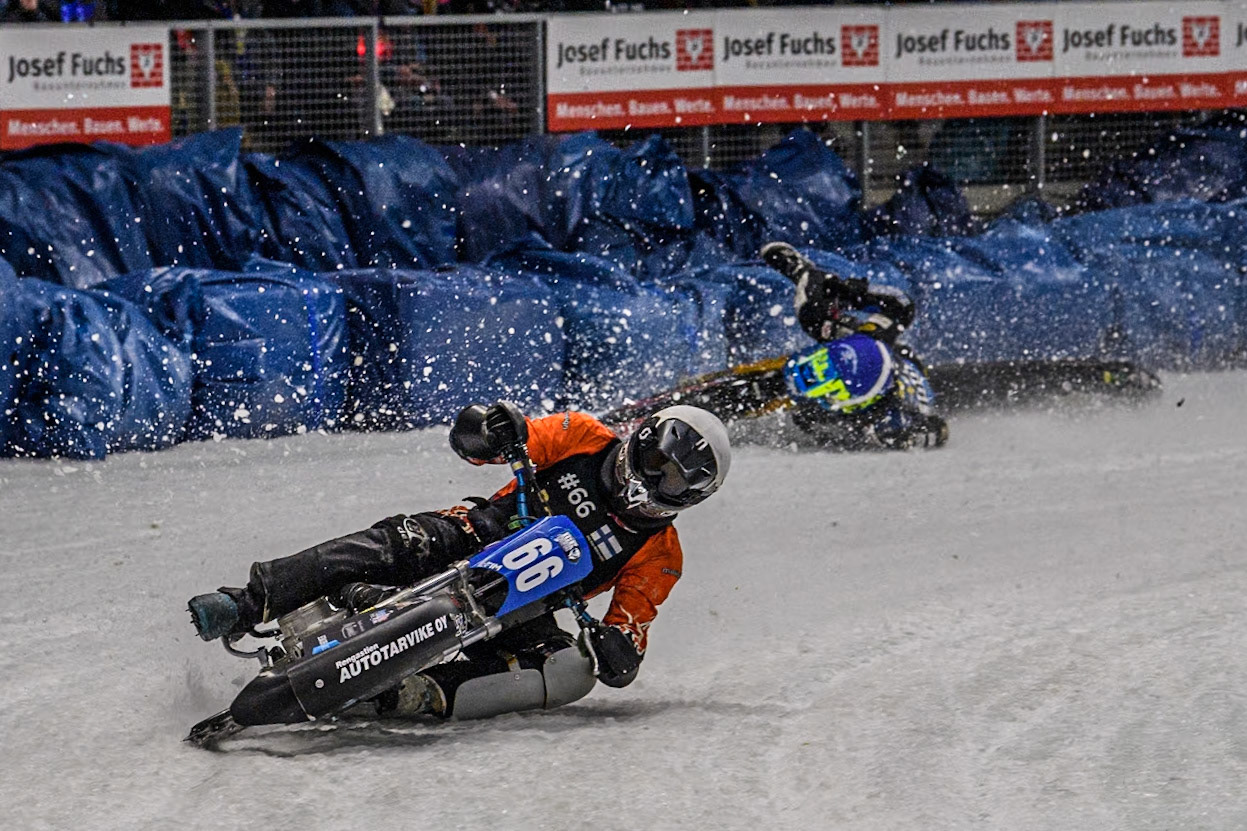 Finland's Aki Ala-Riihimäki (66) (White) leads  as Sweden's Martin Haarahiltunen (199)  (Blue) crashes out during the FIM Ice Speedway Gladiators World Championship Final 2 at the Max-Aicher-Arena, Inzell on Sunday 24 March 2024. (Photo: Ian Charles | MI News)