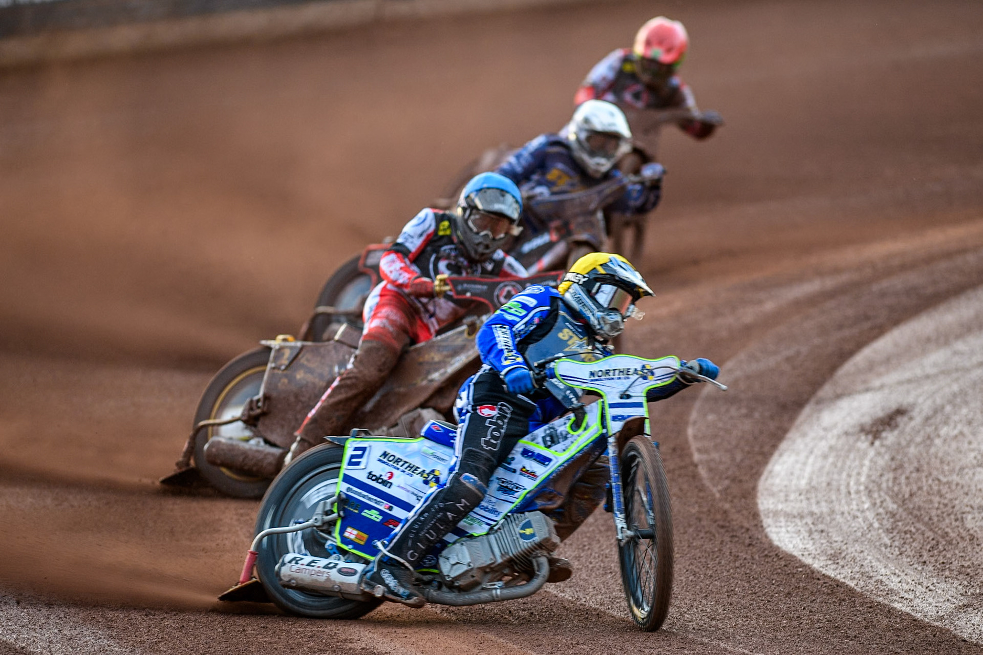 Kings Lynn Stars' Guest Rider Chris Harris  in Yellow leading Belle Vue Aces' Norick Blodorn  in Blue , Kings Lynn Stars' Jan Kvech  in White  and Belle Vue Aces' Dan Bewley  in Red during the Rowe Motor Oil Premiership match between Belle Vue Aces and King's Lynn Stars at the National Speedway Stadium, Manchester on Monday 12th August 2024. (Photo: Ian Charles | MI News)