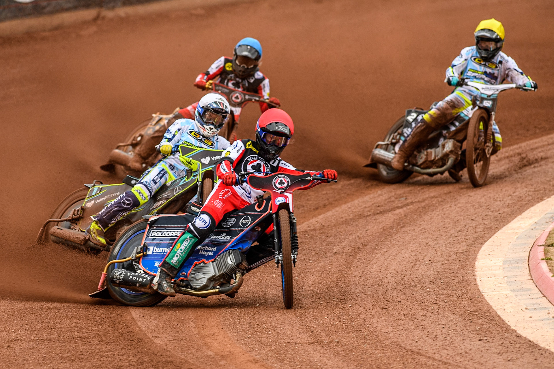 Belle Vue Aces' Brady Kurtz  in Red leading Oxford Spires' Rohan Tungate in White Belle Vue Aces' Norick Blodorn in Blue and Oxford Spires' Erik Riss in Yellow during the Rowe Motor Oil Premiership match between Belle Vue Aces and Oxford Spires at the National Speedway Stadium, Manchester on Monday 22nd July 2024. (Photo: Ian Charles | MI News)