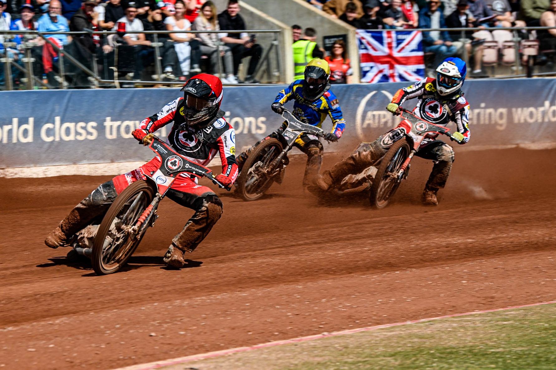 Belle Vue Aces' Norick Blödorn  in Red leading Sheffield Tigers' Guest Rider Joe Thompson  in Yellow and Belle Vue Aces' Jake Mulford in Blue during the Rowe Motor Oil Premiership match between Belle Vue Aces and Sheffield Tigers at the National Speedway Stadium, Manchester on Monday 26th August 2024. (Photo: Ian Charles | MI News)