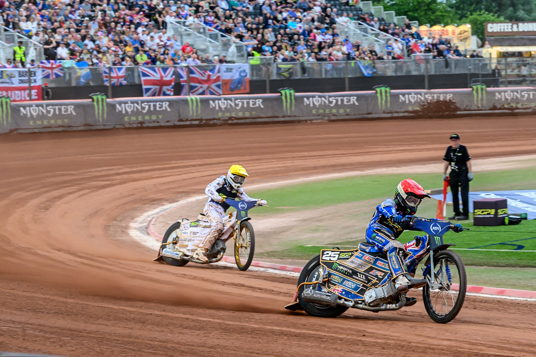 Jack Holder (25) of Australia in Red leading Anders Thomsen (105) of Denmark in Yellow during the ATPI FIM Speedway Grand Prix Round 4 at the National Speedway Stadium, Manchester, on Friday 13th June 2025. (Photo: Ian Charles | MI News)