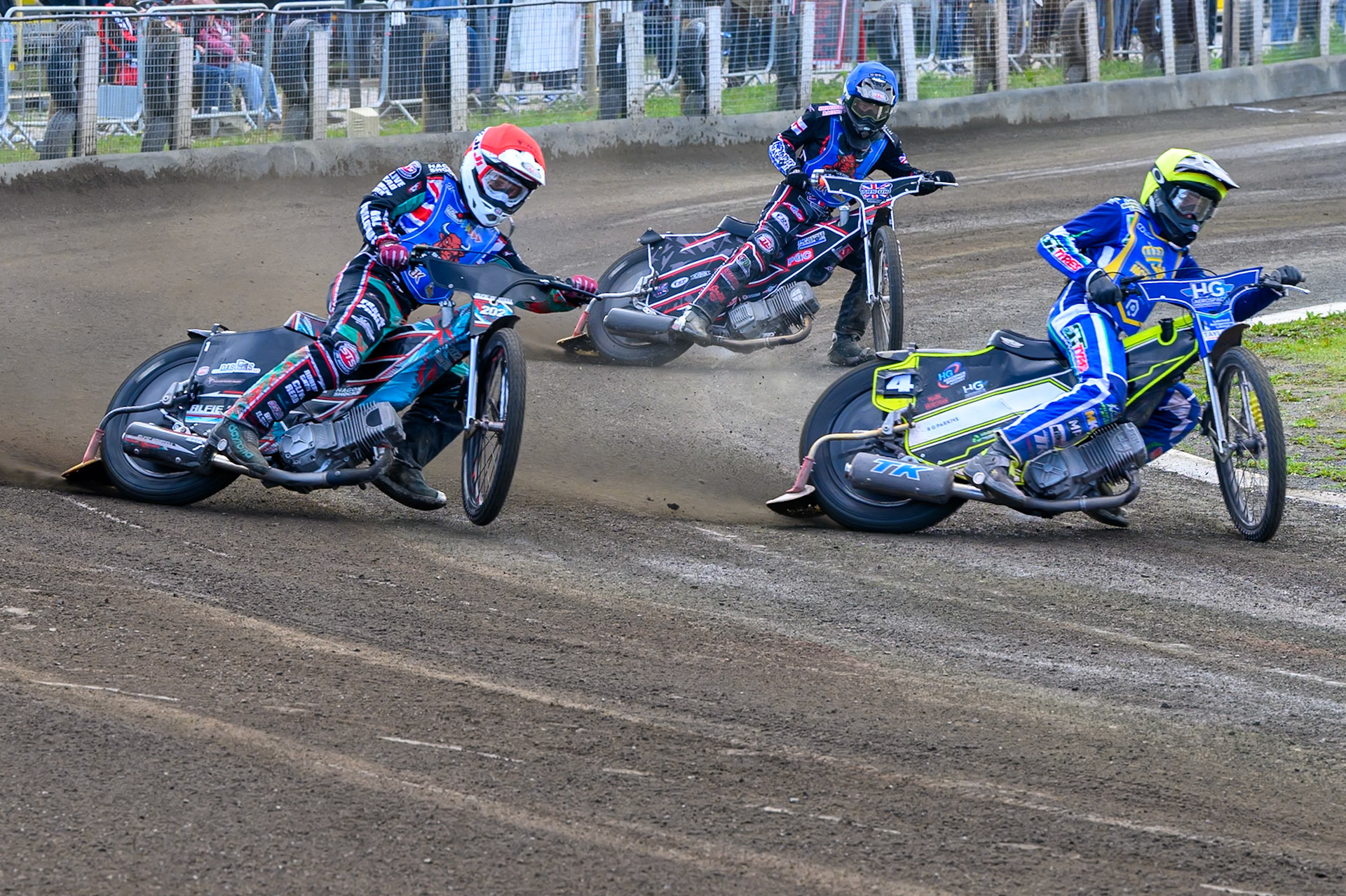 Vinnie Foord of Edinburgh Monarchs Academy in Yellow leading Alfie Bowtell of Buxton Bulls in Red and Jack Shimelt of Buxton Bulls in Blue during the WSRA National Development League match between Buxton Bulls and Edinburgh Monarchs Academy at Hi-Edge Speedway, Buxton on Sunday 14th June 2026. (Photo: Ian Charles | MI News)