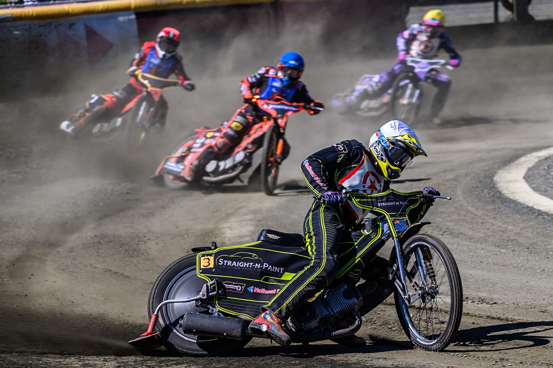 Ben Whalley of Stoke Potters in White leading Alex Spooner guest rider for Buxton Bulls in Blue, Luke Harris of Buxton Bulls in Red and Sam Woods of Stoke Potters in Yellow during the National Development League Challenge match between Buxton Bulls and Stoke Potters at Hi-Edge Speedway, Buxton on Sunday 24th May 2026. (Photo: Ian Charles | MI News)