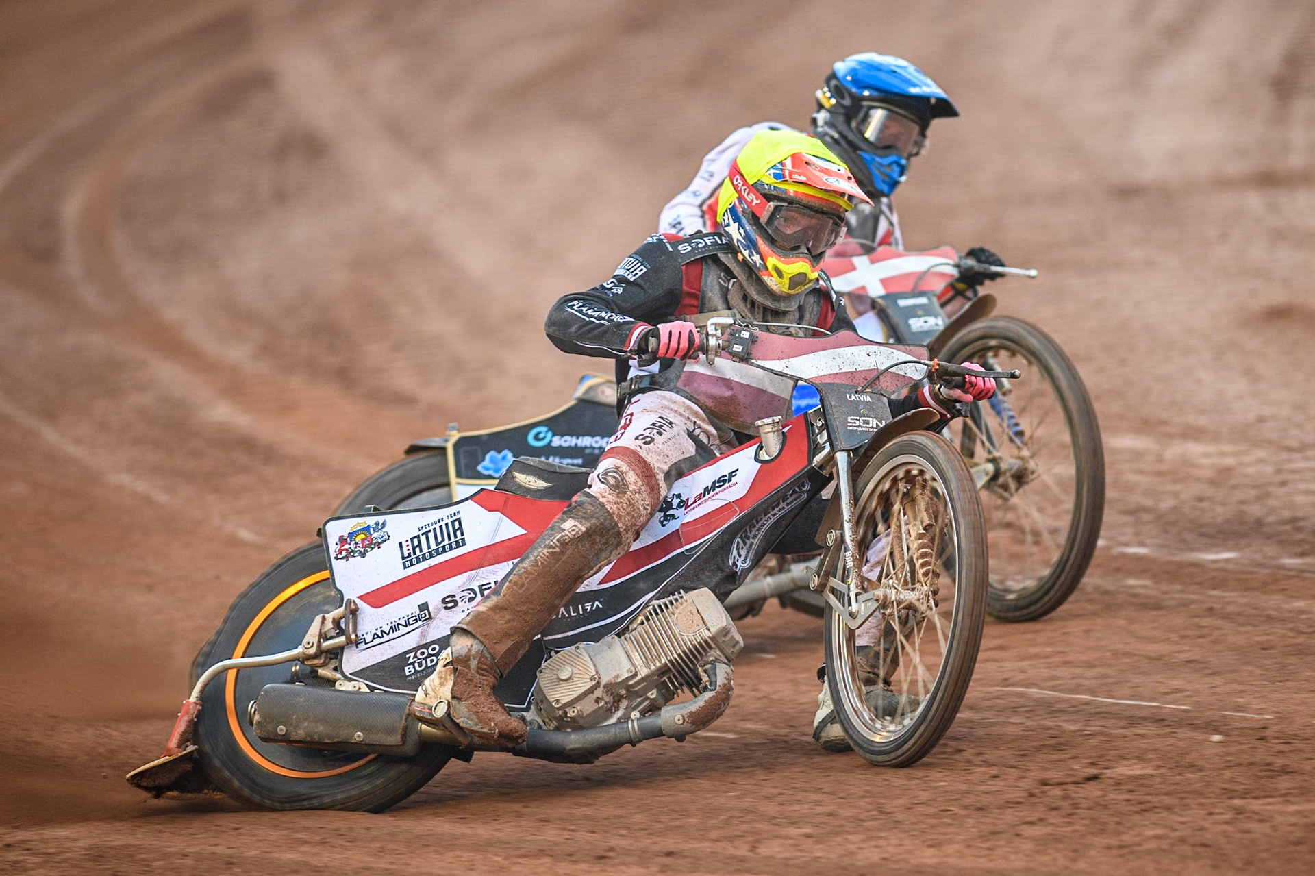 Daniils Kolodinskis of Latvia in Yellow leading Rasmus Jensen of Denmark in Blue during the Monster Energy FIM Speedway of Nation Final at the National Speedway Stadium, Manchester on Saturday 13th July 2024. (Photo: Ian Charles | MI News)