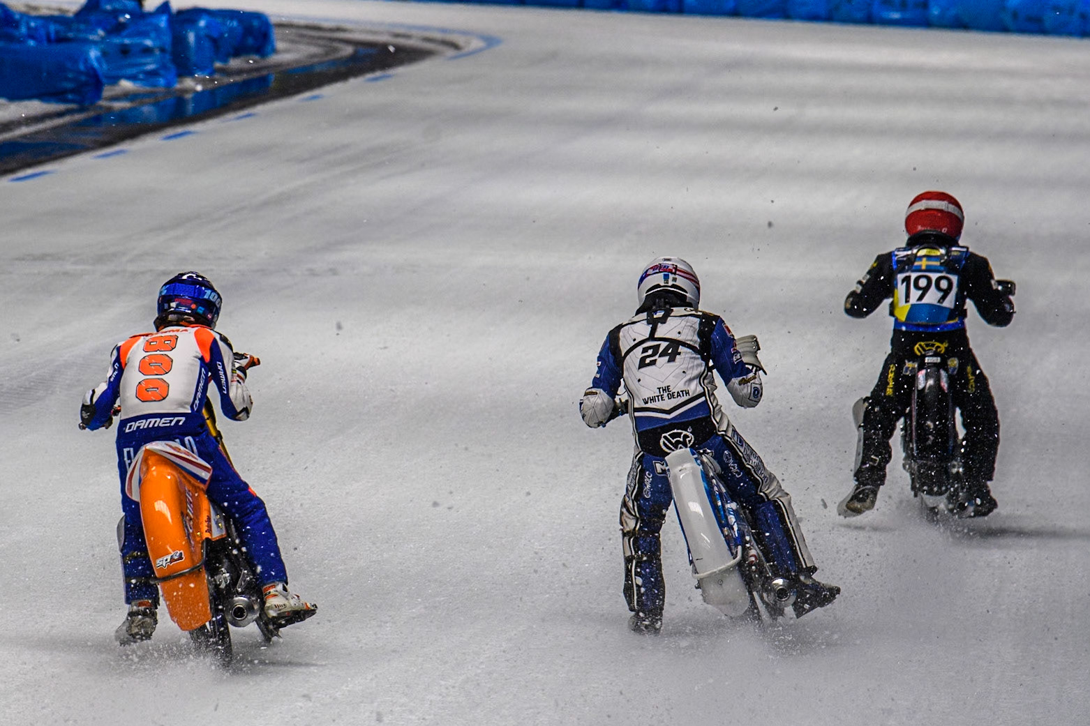 Jasper Iwema (800) of The Netherlands in Blue chases Max Koivula (24) of Finland in White and Martin Haarahiltunen (199) of Sweden in Red during the Ice Speedway Gladiators World Championship Final 1 at Max-Aicher-Arena, Inzell on Saturday 15th March 2025. (Photo: Ian Charles | MI News)