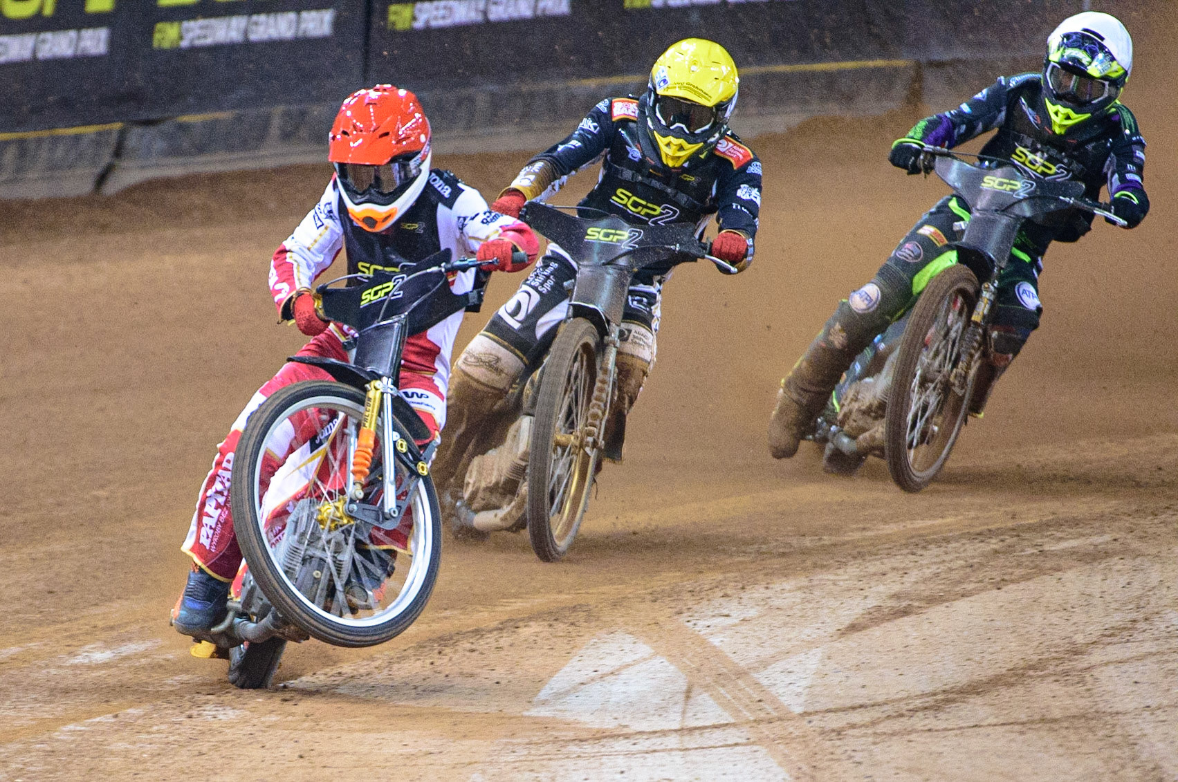Mateusz Cierniak (Poland)  (Red) picks up some drive coming out of the 2nd turn ahead of Norick Blodorn (Germany)  (Yellow) and Tom Brennan (Great Britain)  (White) during the FIM  Speedway Grand Prix  2 of Great Britain at the Principality Stadium, Cardiff on Sunday 14th August 2022. (Credit: Ian Charles | MI News)