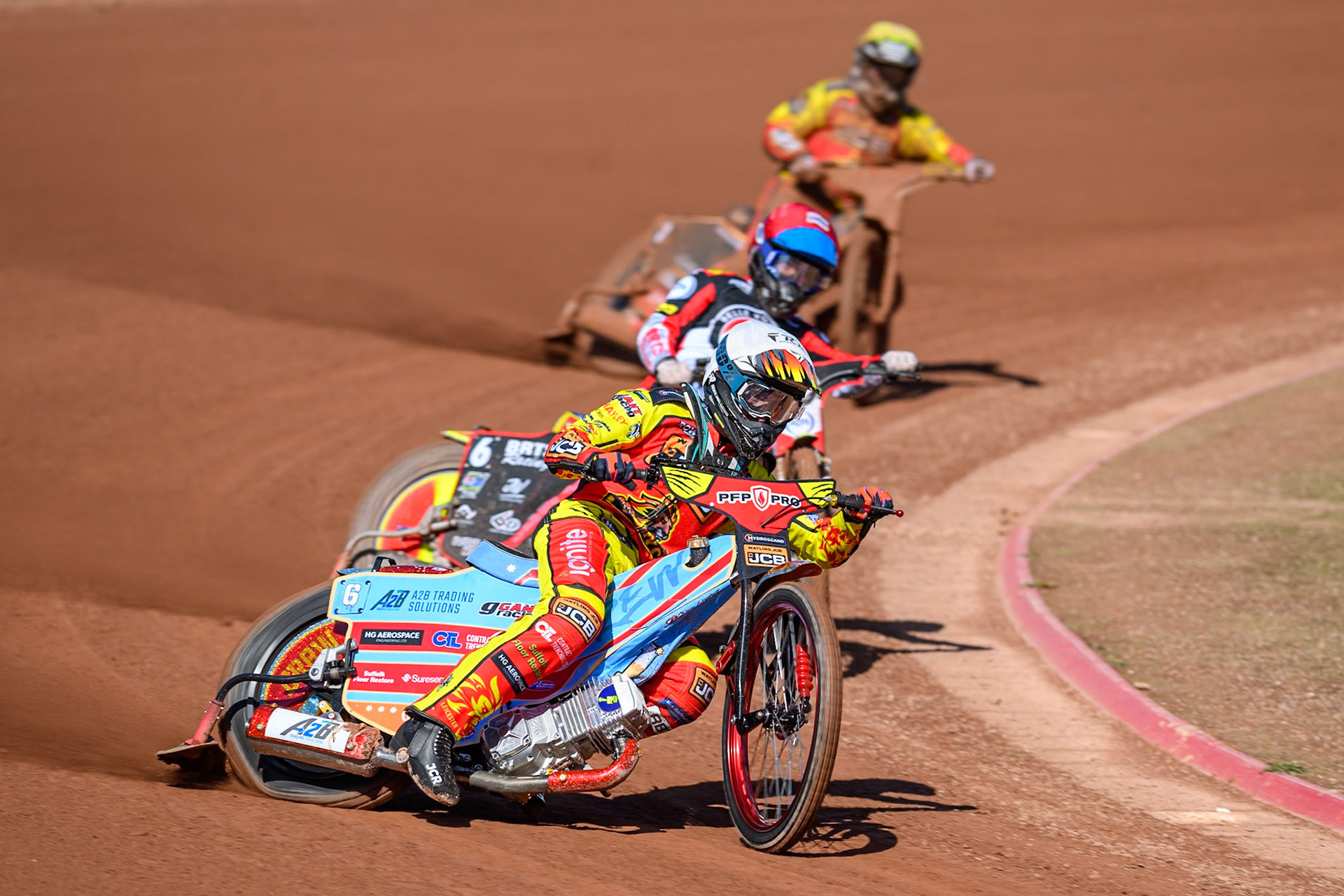 Drew Kemp of Leicester Lions  in White leading Tate Zischke of Belle Vue Aces in Red and Joe Thompson of Leicester Lions  in Yellow during the Knockout Cup Northern Section match between Belle Vue Aces and Leicester Lions at the National Speedway Stadium, Manchester on Monday 6th April 2026. (Photo: Ian Charles | MI News)