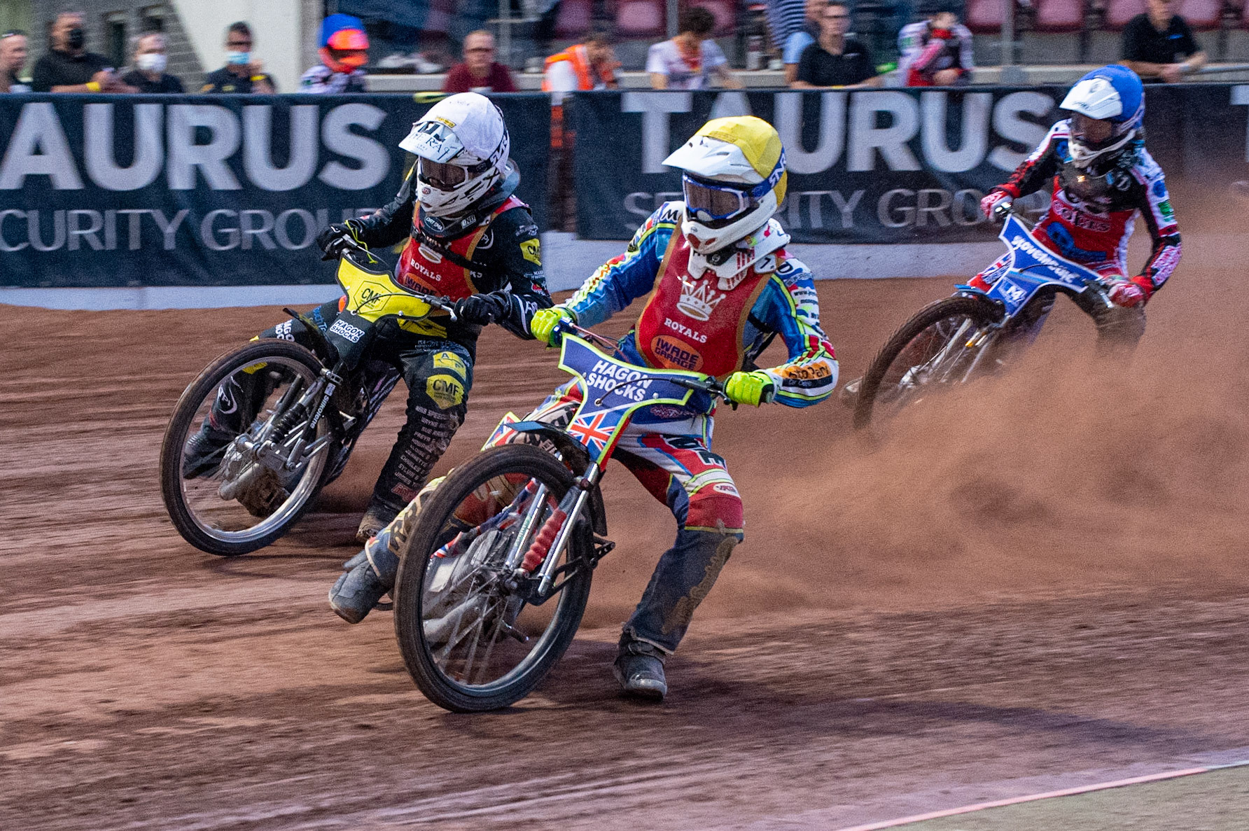 MANCHESTER, UK. JULY 2ND Jake Mulford  (Yellow) and Daniel Gilkes  (White) go for maximum points leading Harry McGurk (Blue) during the National Development League match between Belle Vue Colts and Kent Royals at the National Speedway Stadium, Manchester on Friday 2nd July 2021. (Credit: Ian Charles | MI News)