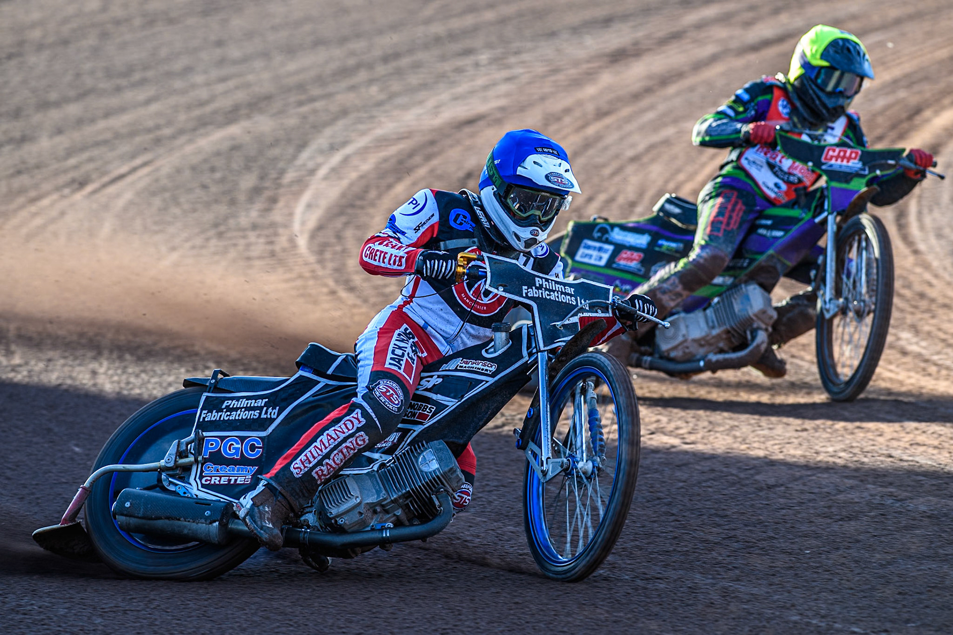 Belle Vue Colts' Jack Shimelt in Blue leading Middlesbrough Tigers' Kai Ward in Yellow during the WSRA National Development League match between Belle Vue Colts and Middlesbrough Tigers at the National Speedway Stadium, Manchester on Monday 17th June 2024. (Photo: Ian Charles | MI News)