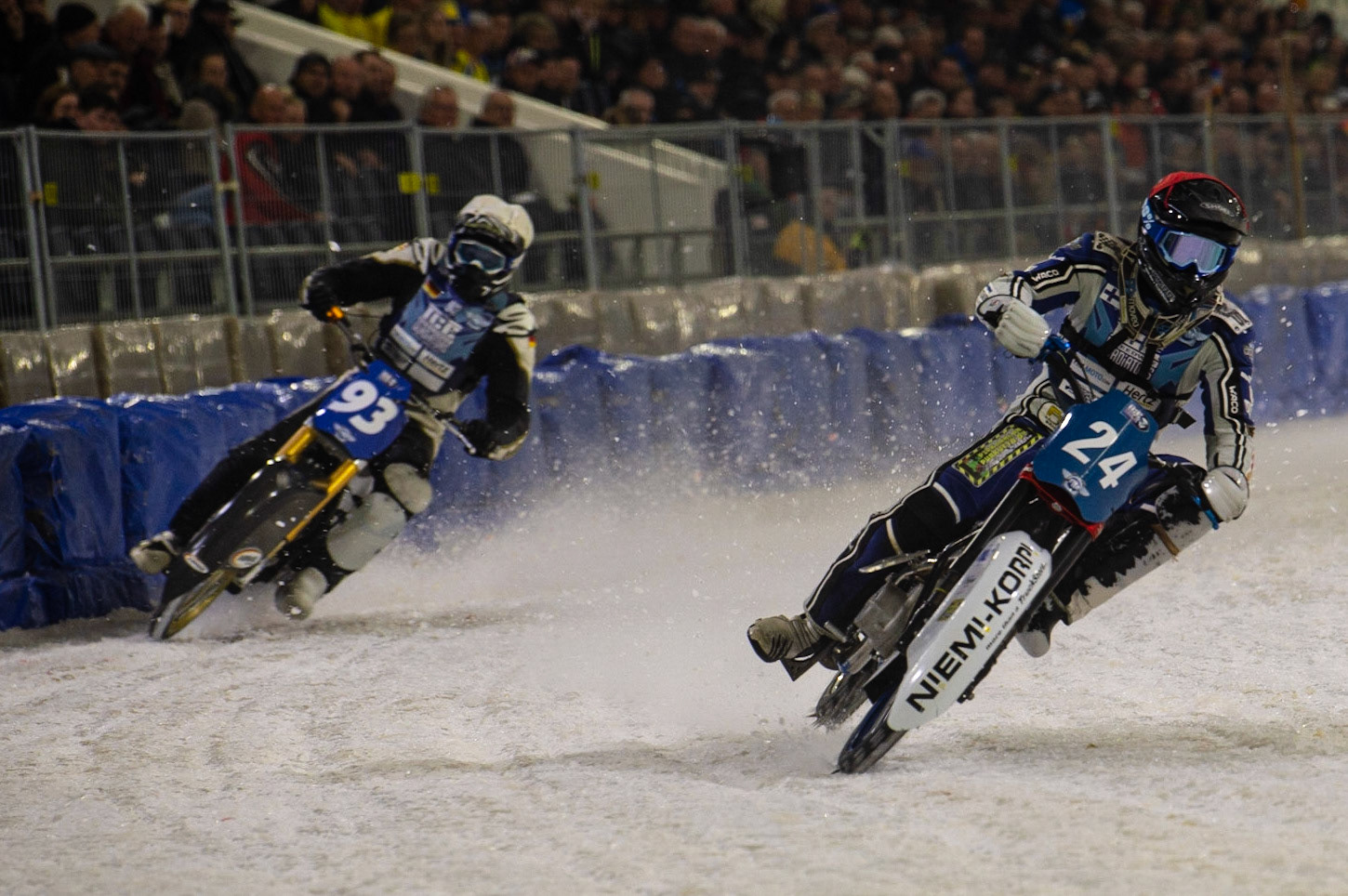 HEERENVEEN, NL. Max Koivula (24) (Red) leads Franz Mayerbüchler (93) (White) during the FIM Ice Speedway Gladiators World Championship Final 3 at Ice Rink Thialf, Heerenveen on Saturday  2 April 2022. (Credit: Ian Charles | MI News)