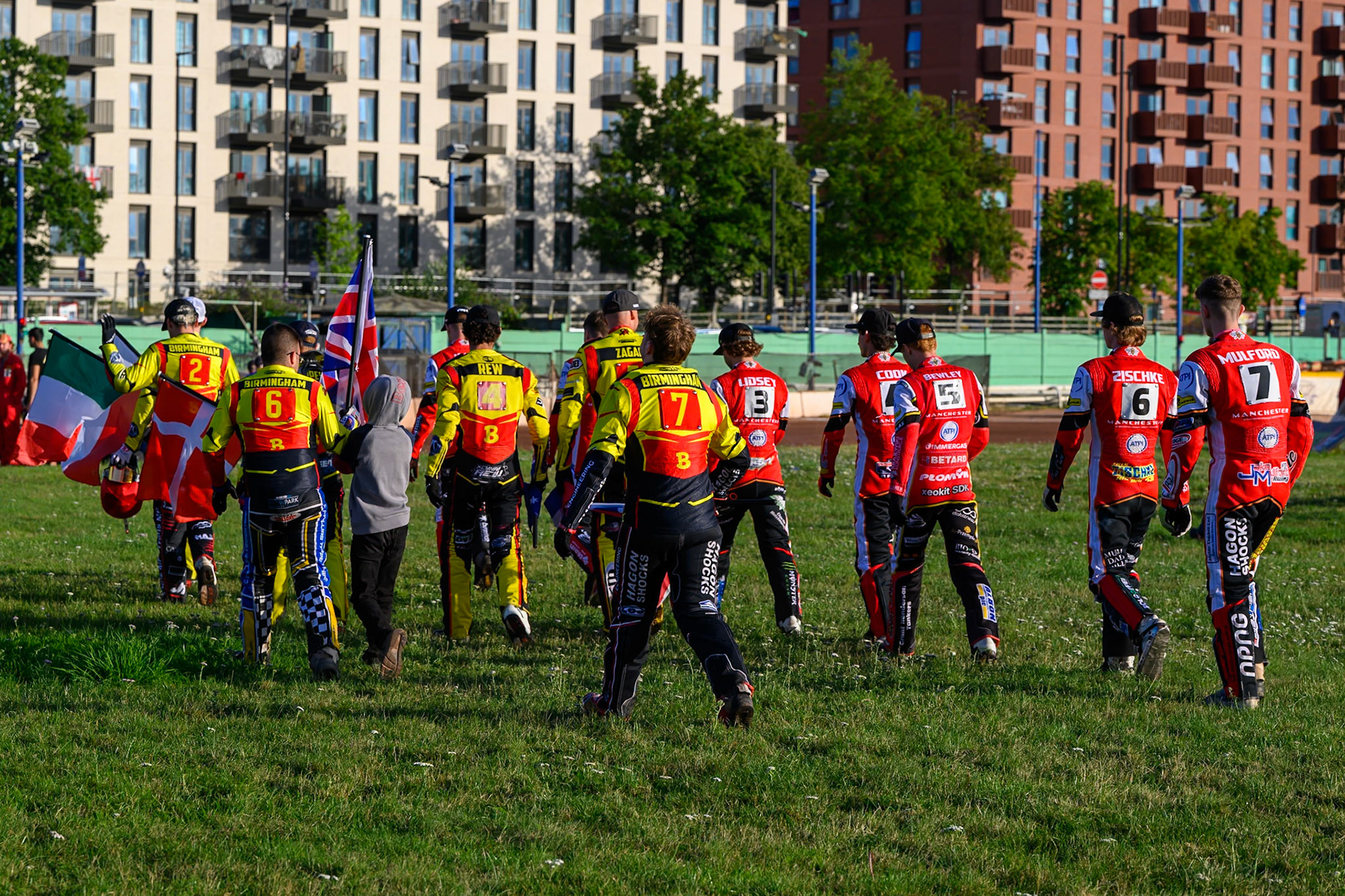 The teams walk across the centre to the start line for the prematch introductions during the Rowe Motor Oil Premiership match between Birmingham Brummies and Belle Vue Aces at Perry Barr Stadium, Birmingham on Monday 28th July 2025. (Photo: Ian Charles | MI News)