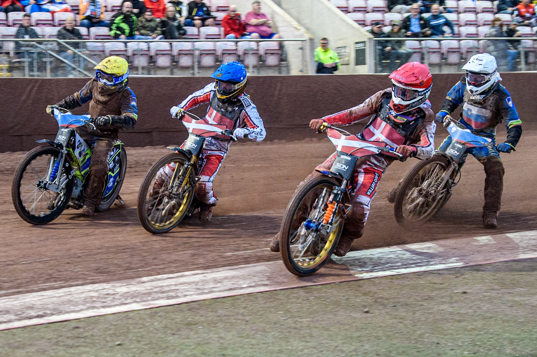 Mikkel Michelsen of Denmark in Red and Anders Thomsen of Denmark in Blue leading Matic Ivacic of Slovenia in Yellow and Anze Grmek of Slovenia in White in their meeting winning heat during the Monster Energy FIM Speedway of Nation Semi Final 2 at the National Speedway Stadium, Manchester on Wednesday 10th July 2024. (Photo: Ian Charles | MI News)