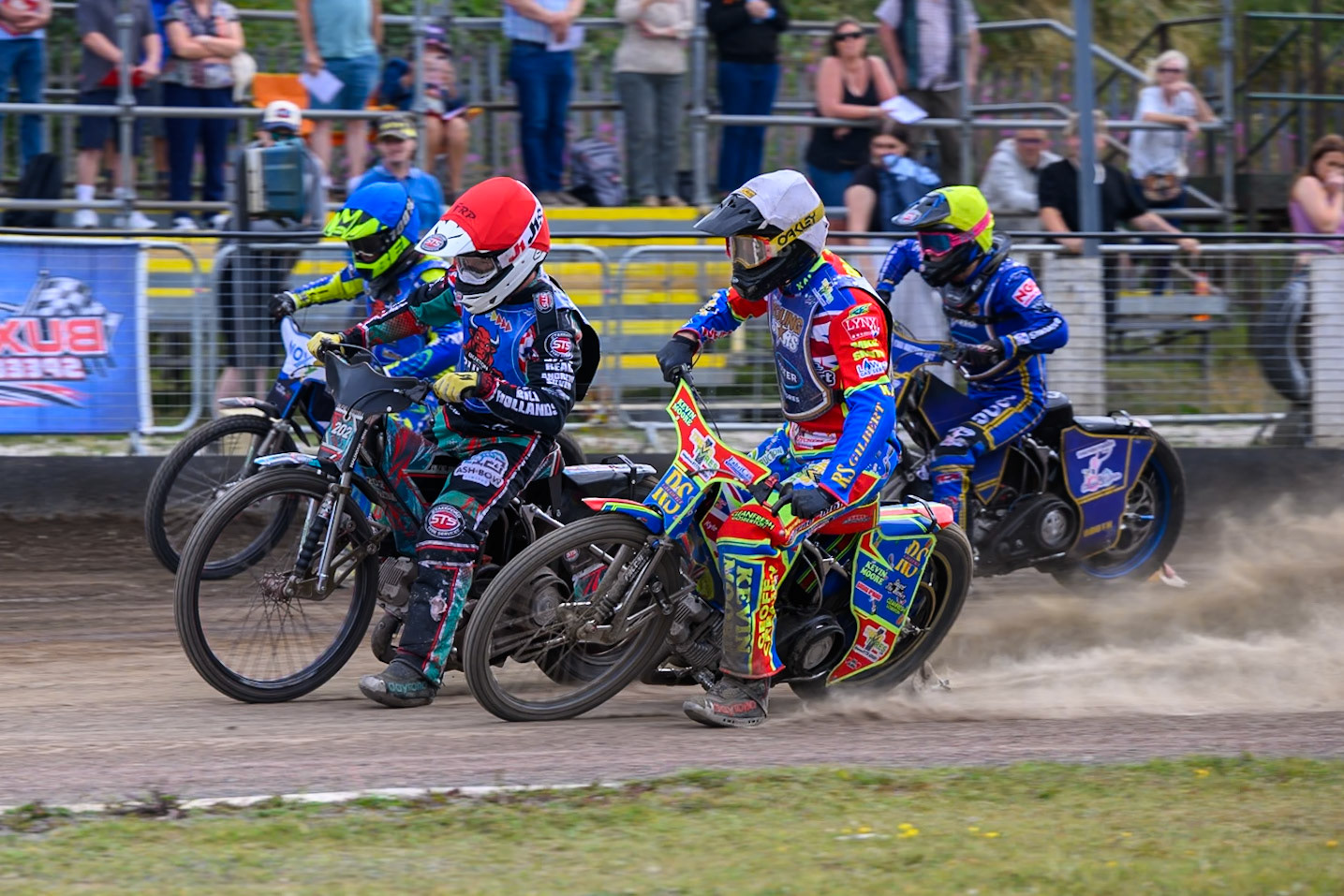 Alfie Bowtell of Buxton Bulls in Red  rides outside Simon Lambert of Kings Lynn Young Stars in White  with Will Boraston of Buxton Bulls in Blue  and Ollie Binns of Kings Lynn Young Stars in Yellow  during the WSRA National Development League match between Buxton Bulls and King's Lynn Young Stars at Hi-Edge Speedway, Buxton on Sunday 9th August 2026. (Photo: Ian Charles | MI News)