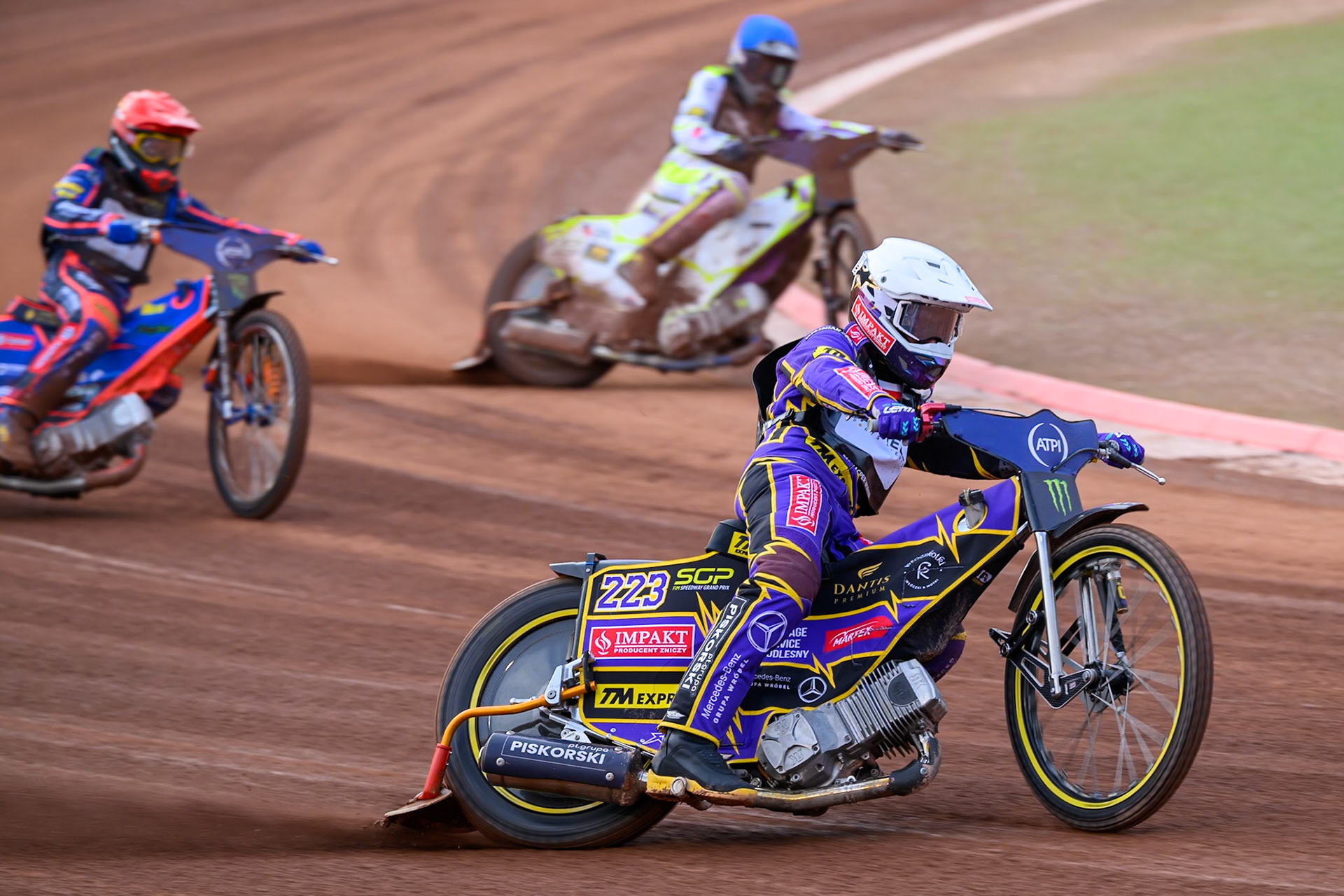 Kacper Woryna (223) of Poland leading Wild Card Tom Brennan (16) of Great Britain in Blue and Andzejs Lebedevs (29) of Latvia in Red during the ATPI  FIM Speedway GP of Manchester at the National Speedway Stadium, Manchester on Friday 5th June 2026. (Photo: Ian Charles | MI News)