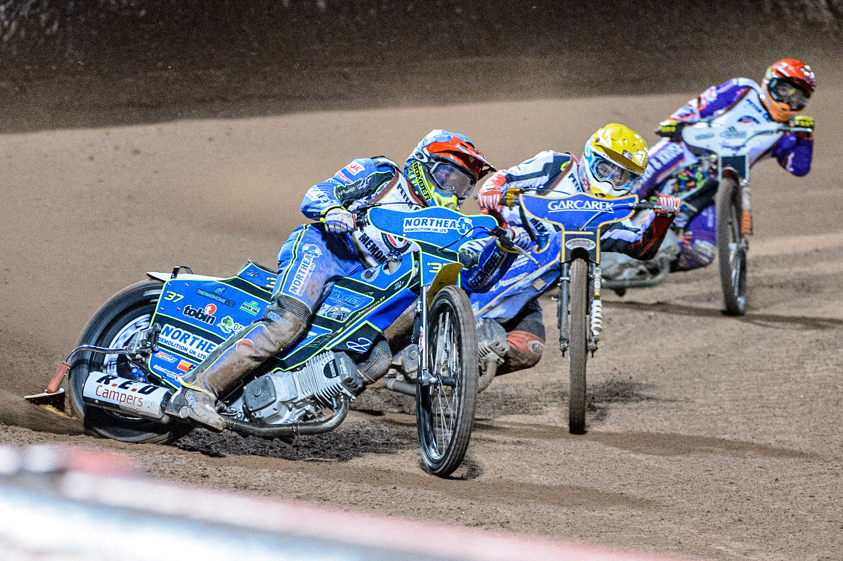 Chris Harris (Blue) leads Robert Lambert  (Yellow) and Niels-Kristian Iversen  (Red) during the Peter Craven Memorial Trophy  at the National Speedway Stadium, Manchester on Monday 3rd April 2023. (Photo: Ian Charles | MI News)
