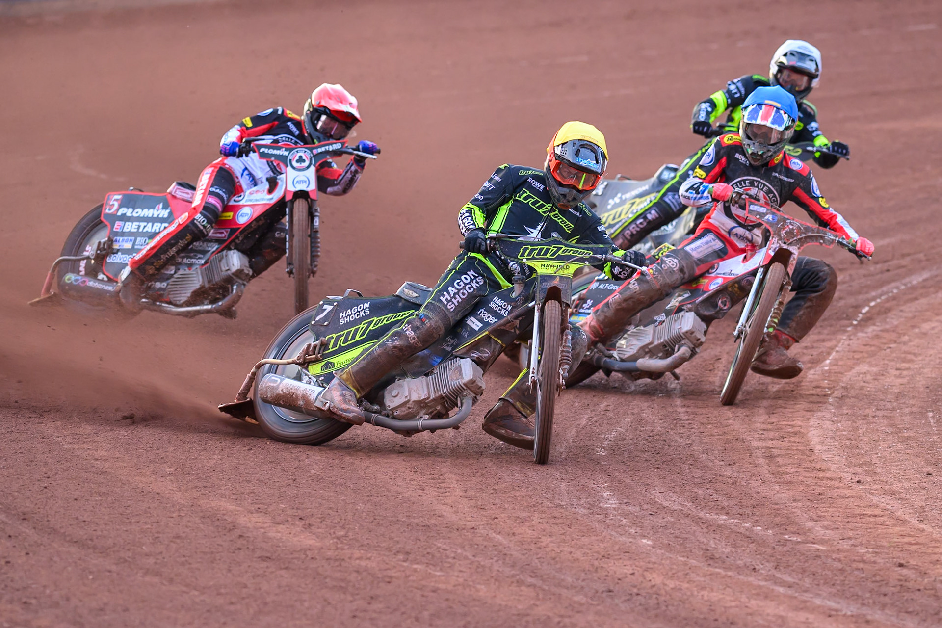 Jason Edwards of Ipswich Witches  in Yellow leading Will Cairns of Belle Vue Aces  in Blue, Dan Bewley of Belle Vue Aces  in Red and Tobiasz Musielak of Ipswich Witches  in White during the Rowe Motor Oil Premiership match between Belle Vue Aces and Ipswich Witches at the National Speedway Stadium, Manchester on Monday 20th April 2026. (Photo: Ian Charles | MI News)