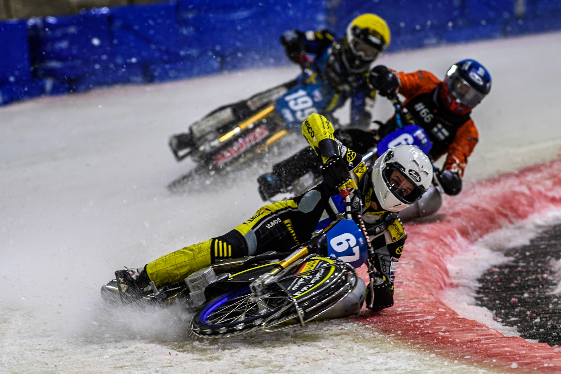 Finland's Heikki Huusko (67) in White leading Finland's Aki Ala-Riihimäki (66) in Blue and Sweden's Martin Haarahiltunen (199)  in Yellow during the FIM Ice Speedway Gladiators World Championship Final 3 at Ice Rink Thialf, Heerenveen on Saturday 6th April 2024. (Photo: Ian Charles | MI News)