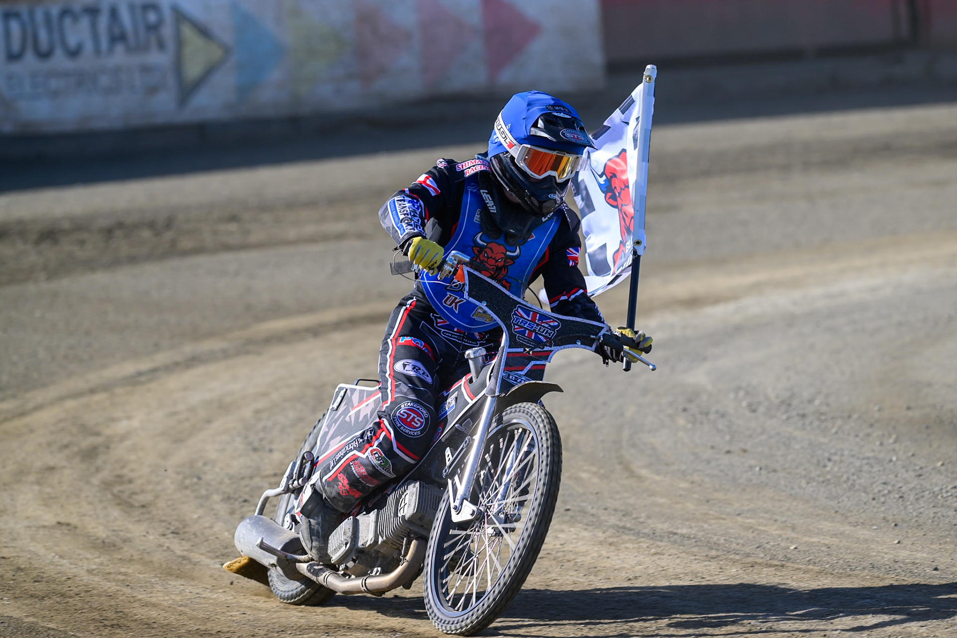 Jack Shimelt of Buxton Bulls  with the club flag after his heat win during the National Development League Challenge match between Buxton Bulls and Stoke Potters at Hi-Edge Speedway, Buxton on Sunday 24th May 2026. (Photo: Ian Charles | MI News)