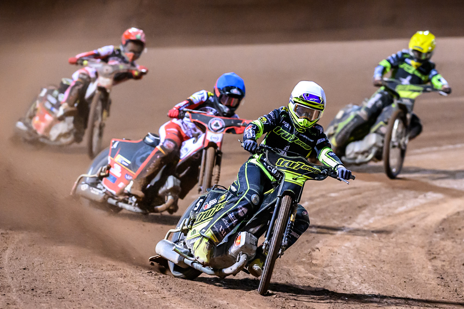 Tom Brennan of Ipswich Witches  in White leading Zach Cook of Belle Vue Aces  in Blue, Jaimon Lidsey of Belle Vue Aces  in Red and Adam Ellis of Ipswich Witches  in Yellow during the Rowe Motor Oil Premiership Play Off Semi Final 1 (1st Leg)  between Belle Vue Aces and Ipswich Witches at the National Speedway Stadium, Manchester on Monday 8th September 2025. (Photo: Ian Charles | MI News)