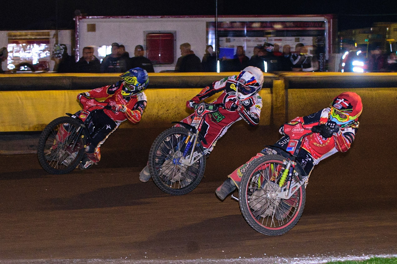 PETERBOROUGH, UK. OCT 14TH Michael Palm Toft  (Red) and Scott Nicholls  (Blue) go either side of Steve Worrall   (White) to take the lead during the SGB Premiership Grand Final 2nd leg between Peterborough and Belle Vue Aces at East of England Showground, Peterborough on Thursday 14th October 2021. (Credit: Ian Charles | MI News)