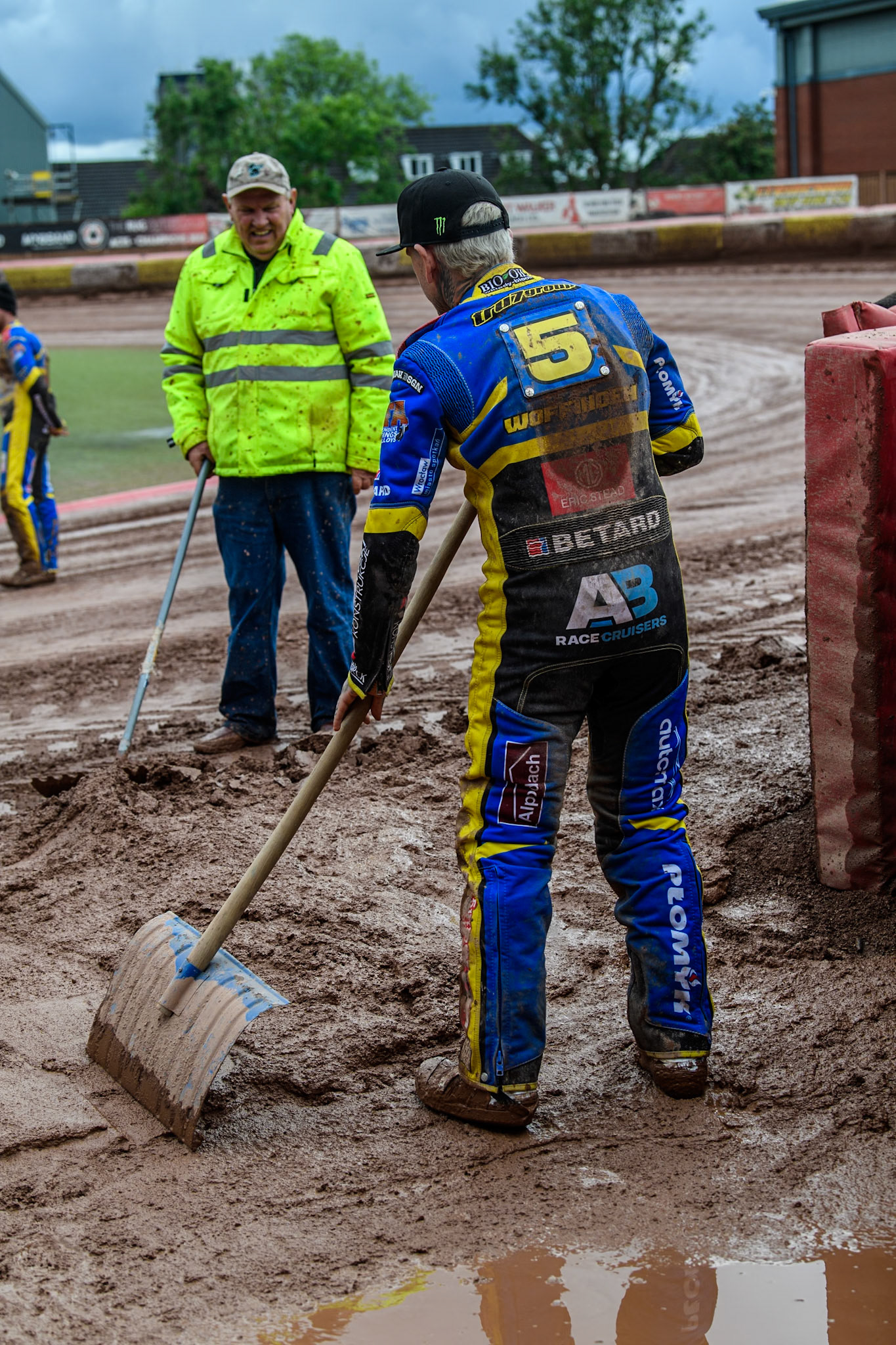 Sheffield Tigers' Tai Woffinden helps to clear the slop from the mouth of the pit gate during the Rowe Motor Oil Premiership match between Belle Vue Aces and Sheffield Tigers at the National Speedway Stadium, Manchester on Monday 27th May 2024. (Photo: Ian Charles | MI News)