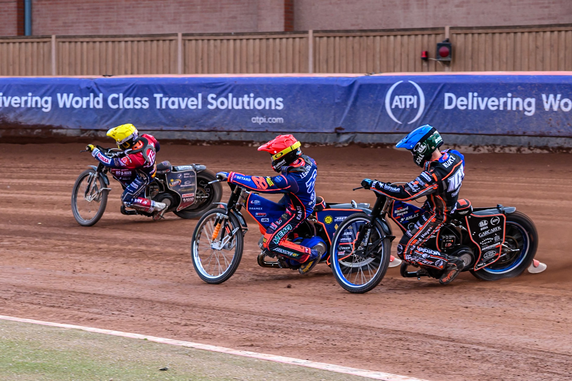 Brady Kurtz (101) of Australia in Blue chases Andzejs Lebedevs (29) of Latvia in Red and Dominik Kubera (415) of Poland in Yellow during the ATPI FIM Speedway Grand Prix Round 4 at the National Speedway Stadium, Manchester, on Friday 13th June 2025. (Photo: Ian Charles | MI News)