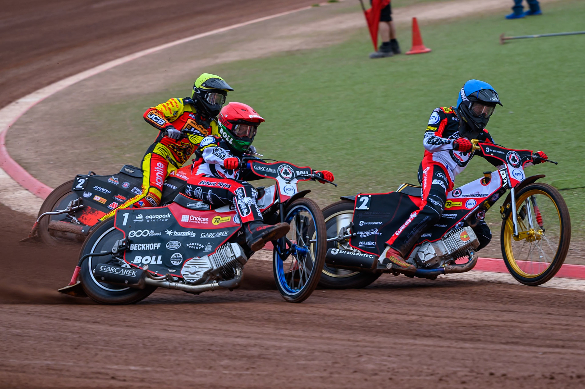 Norick Blödorn of Belle Vue Aces in Blue leading Brady Kurtz of Belle Vue Aces in Red and Dan Thompson of Leicester Lions in Yellow during the Rowe Motor Oil Premiership match between Belle Vue Aces and Leicester Lions at the National Speedway Stadium, Manchester on Monday 15th June 2026. (Photo: Ian Charles | MI News)